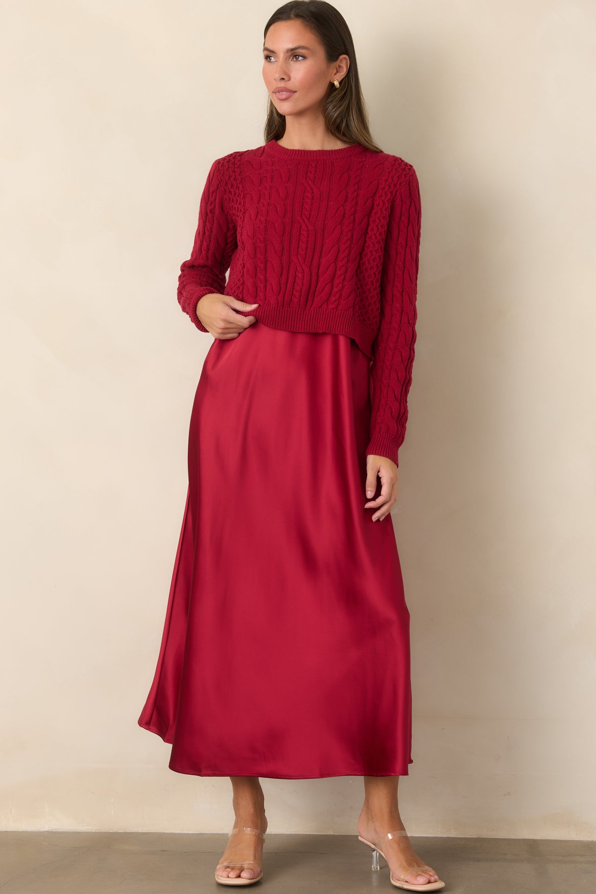A-line satin maxi dress styled with a cropped cotton sweater accented by dimensional cable-knit patterns.