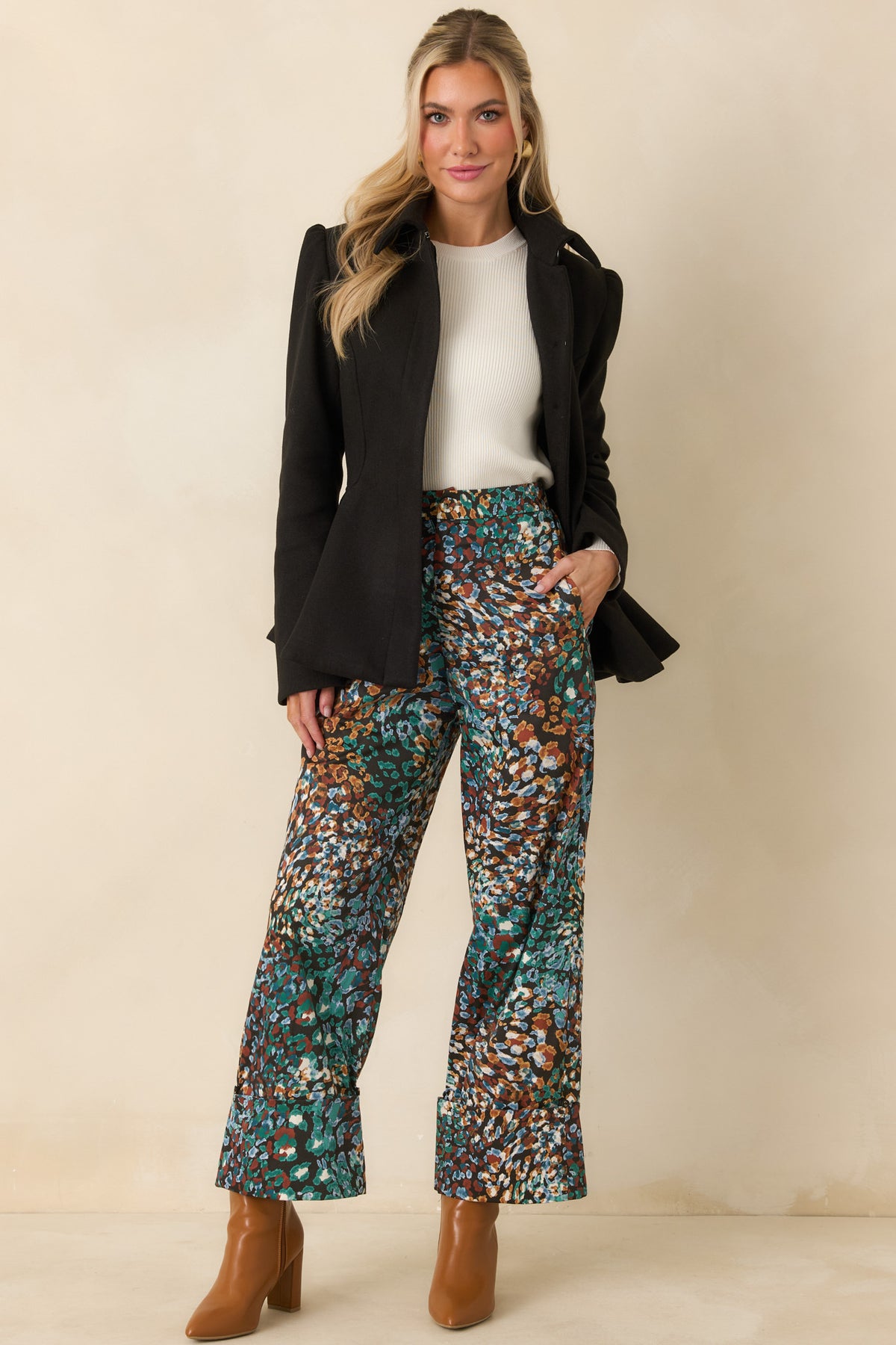Abstract animal print pants with a zipper fly, straight-leg shape, and wide cuffs.