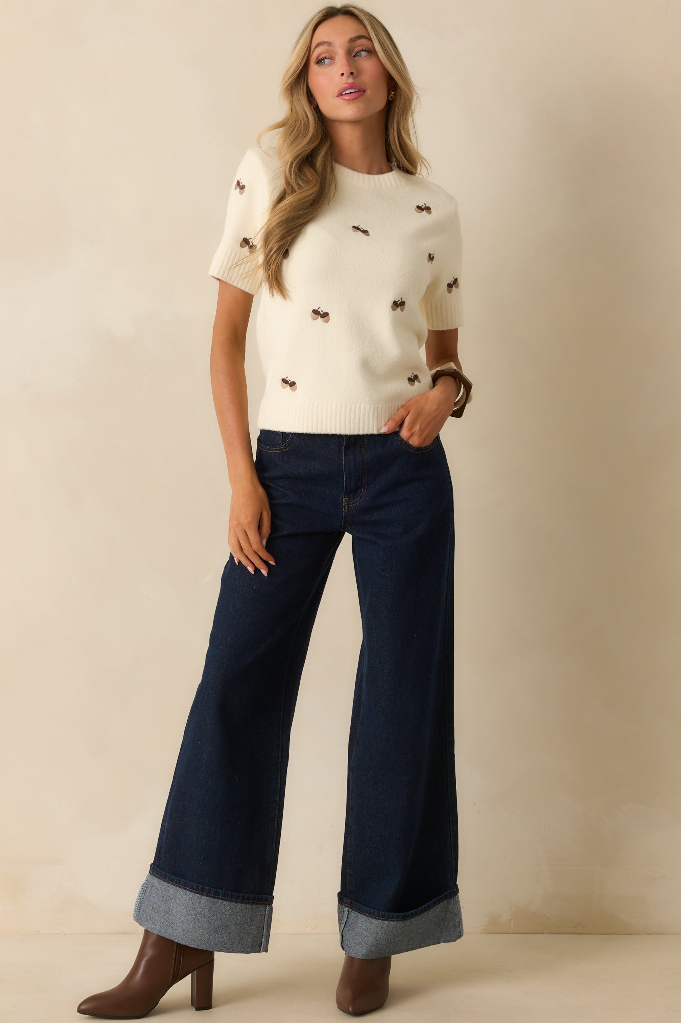 Allover acorn embroidery on a cozy ivory short sleeve top.