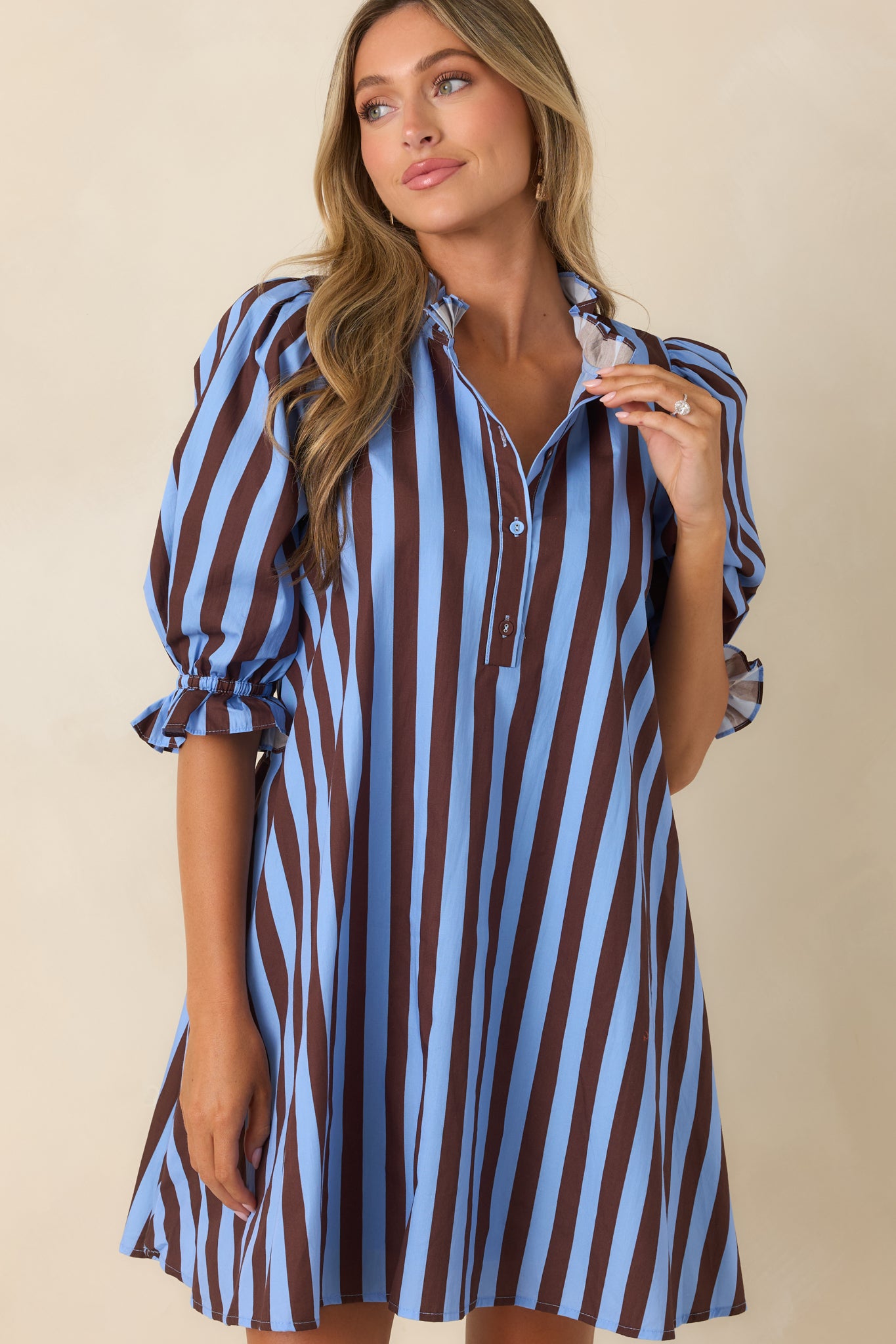 Zoomed-in look at the adjustable tie-back waist detail and soft cotton construction of the striped mini dress.
