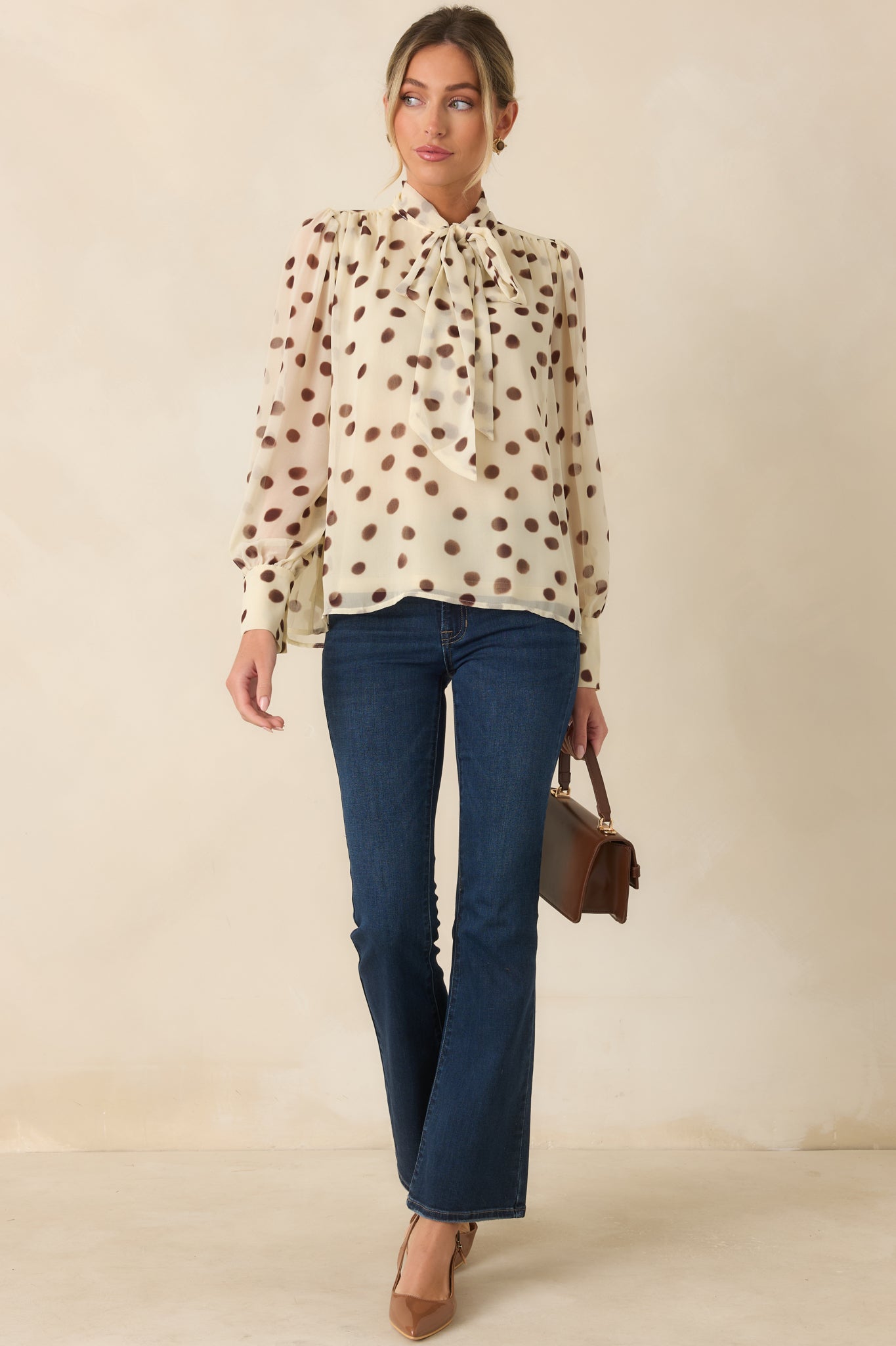 Airy chiffon blouse with a soft ivory base, brown dotted print, button cuffs, and a sophisticated relaxed shape.