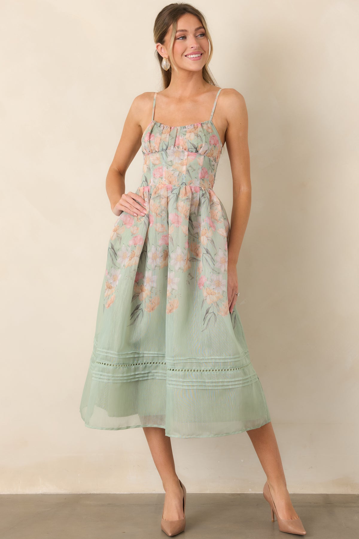 Airy floral dress showcasing slender adjustable straps and a defined waist.