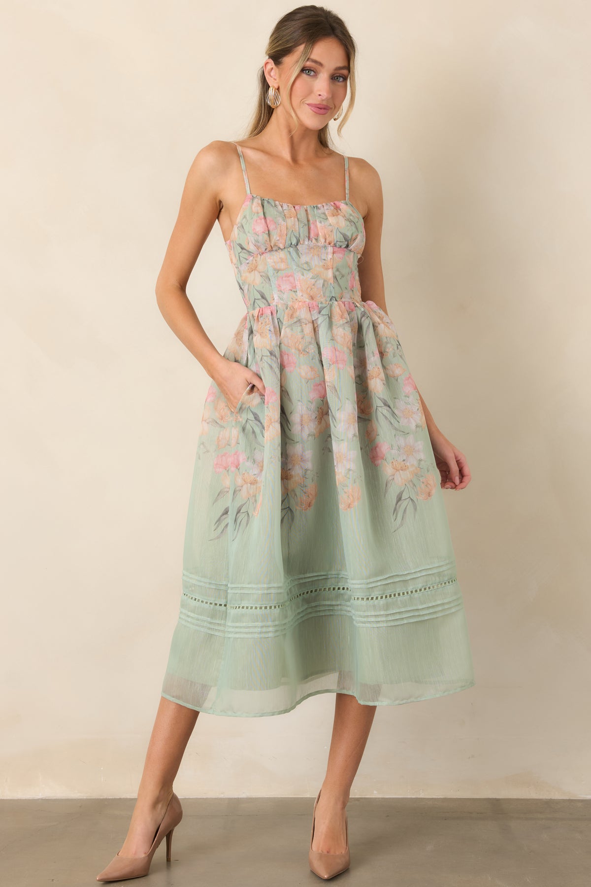 Airy sage floral dress with slender straps and softly shaped bodice.