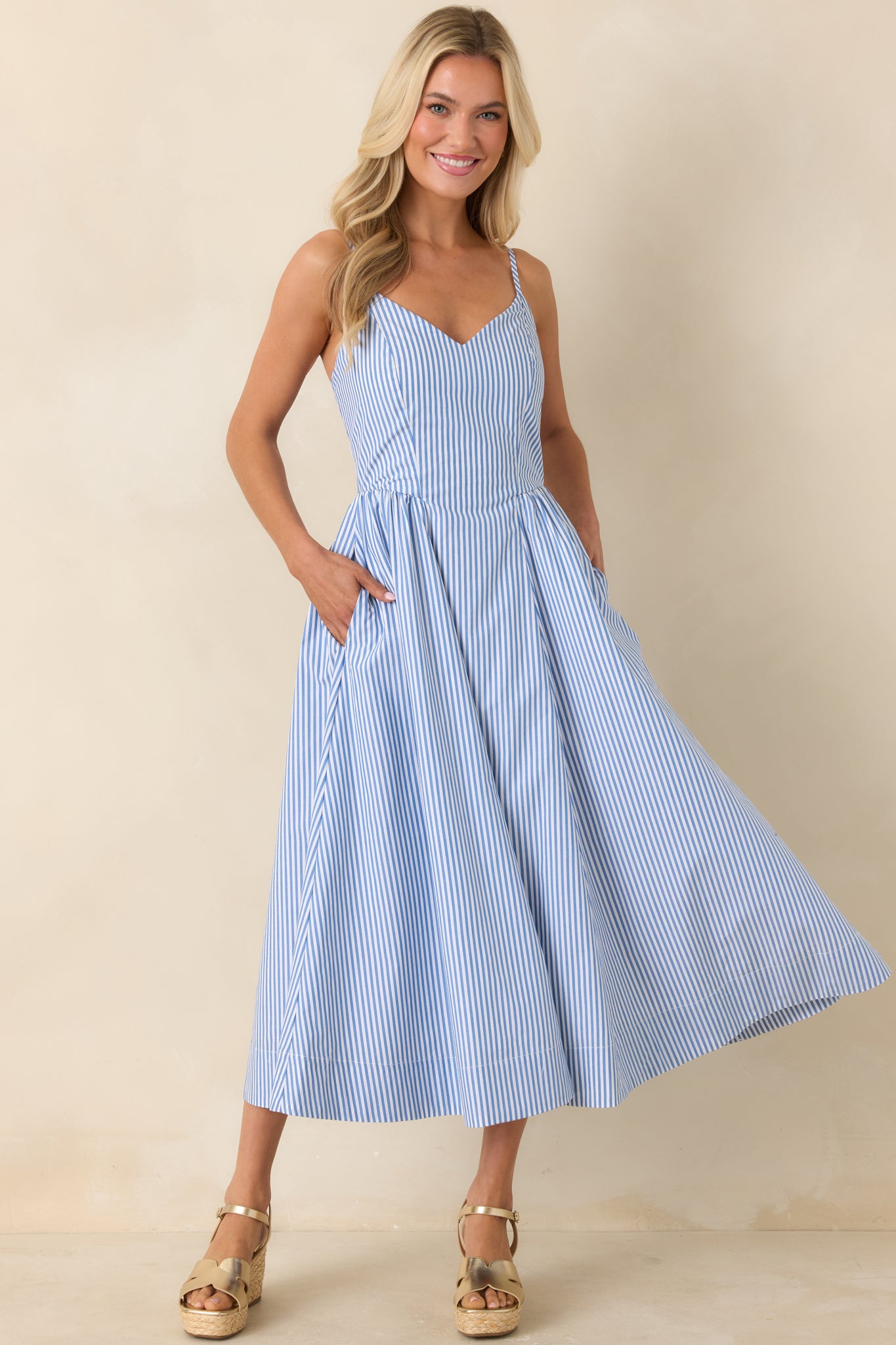 Airy striped midi dress with structured bodice and relaxed flowing hem.