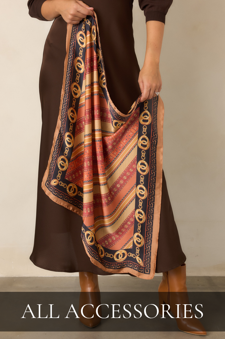 Model holding a multi-color satin scarf. All Accessories.
