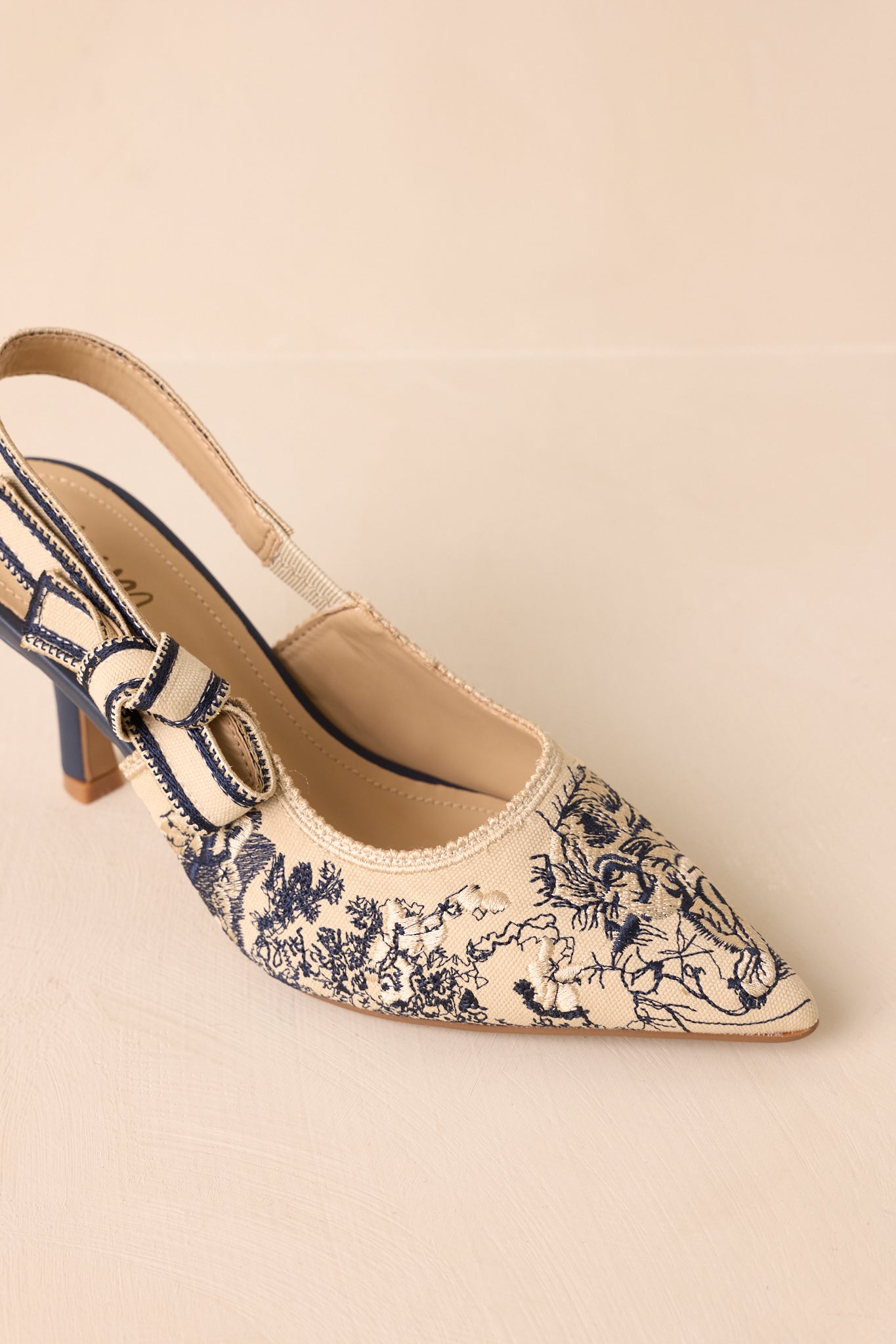 Side angle emphasizing the cushioned footbed and secure elastic slingback strap.