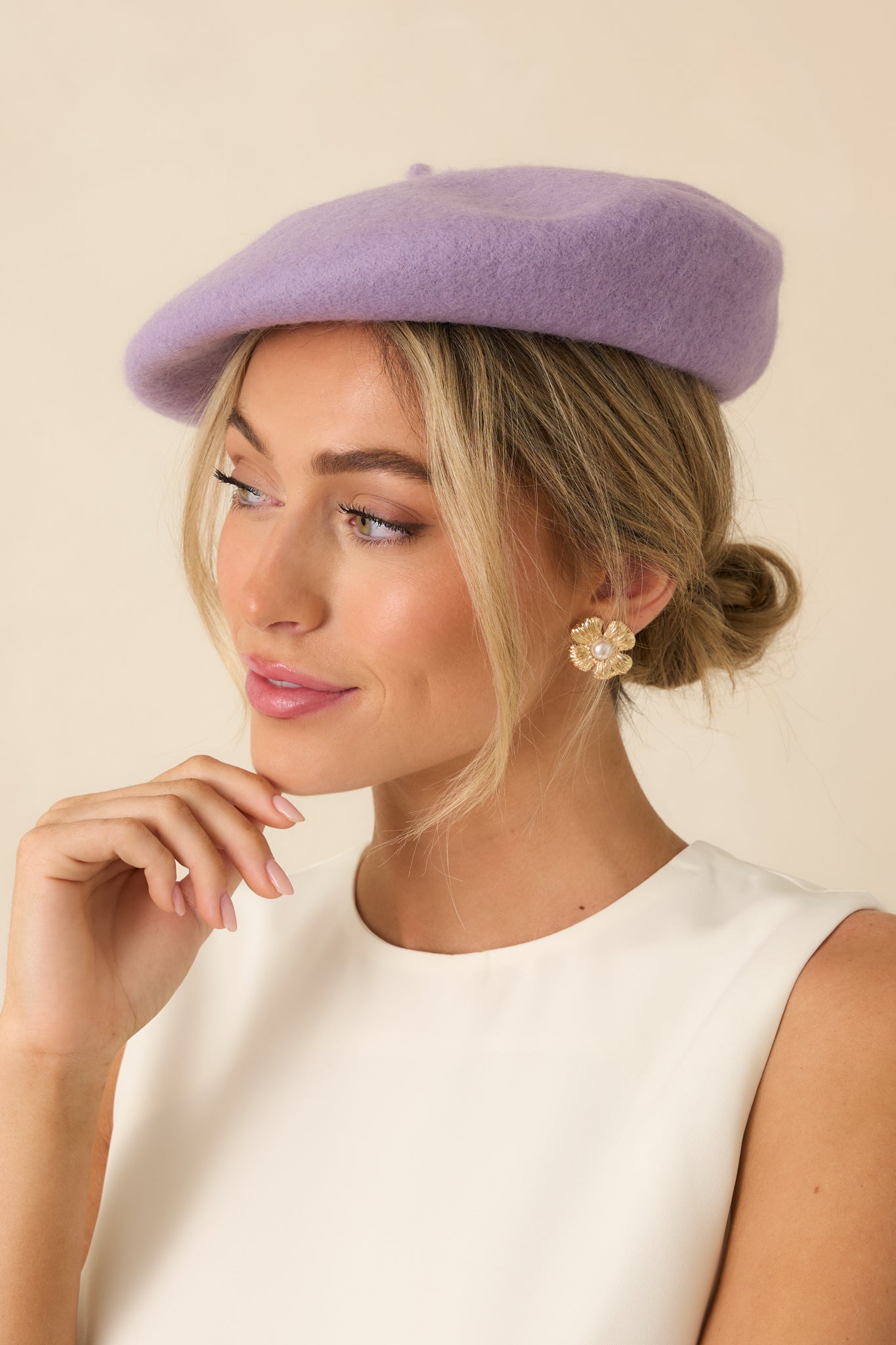 Cropped angle highlighting the round shape and structured feel of the lavender wool beret.