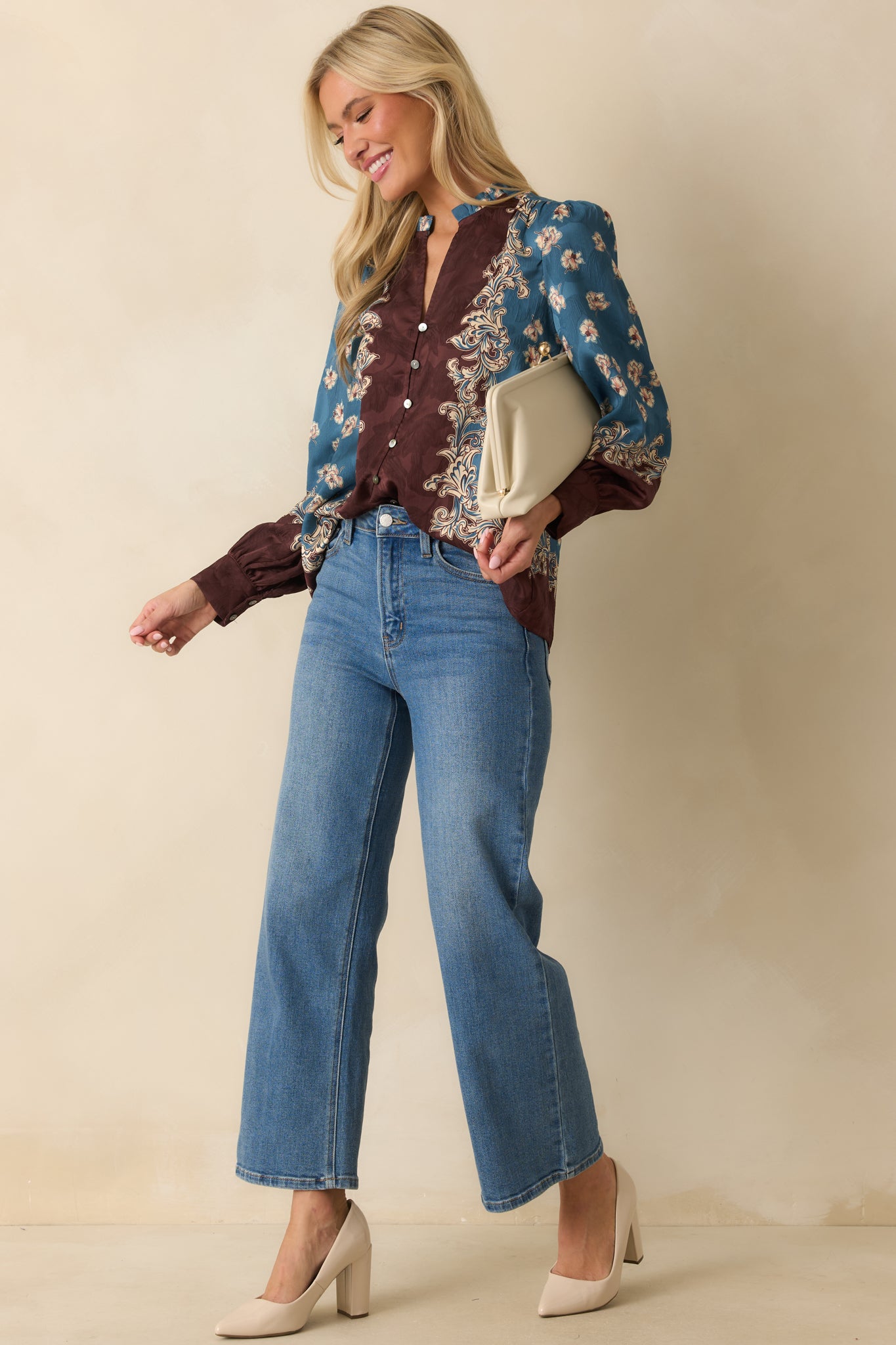 An angled front view emphasizing the functional button front closure and button cuffs on the sleeves.