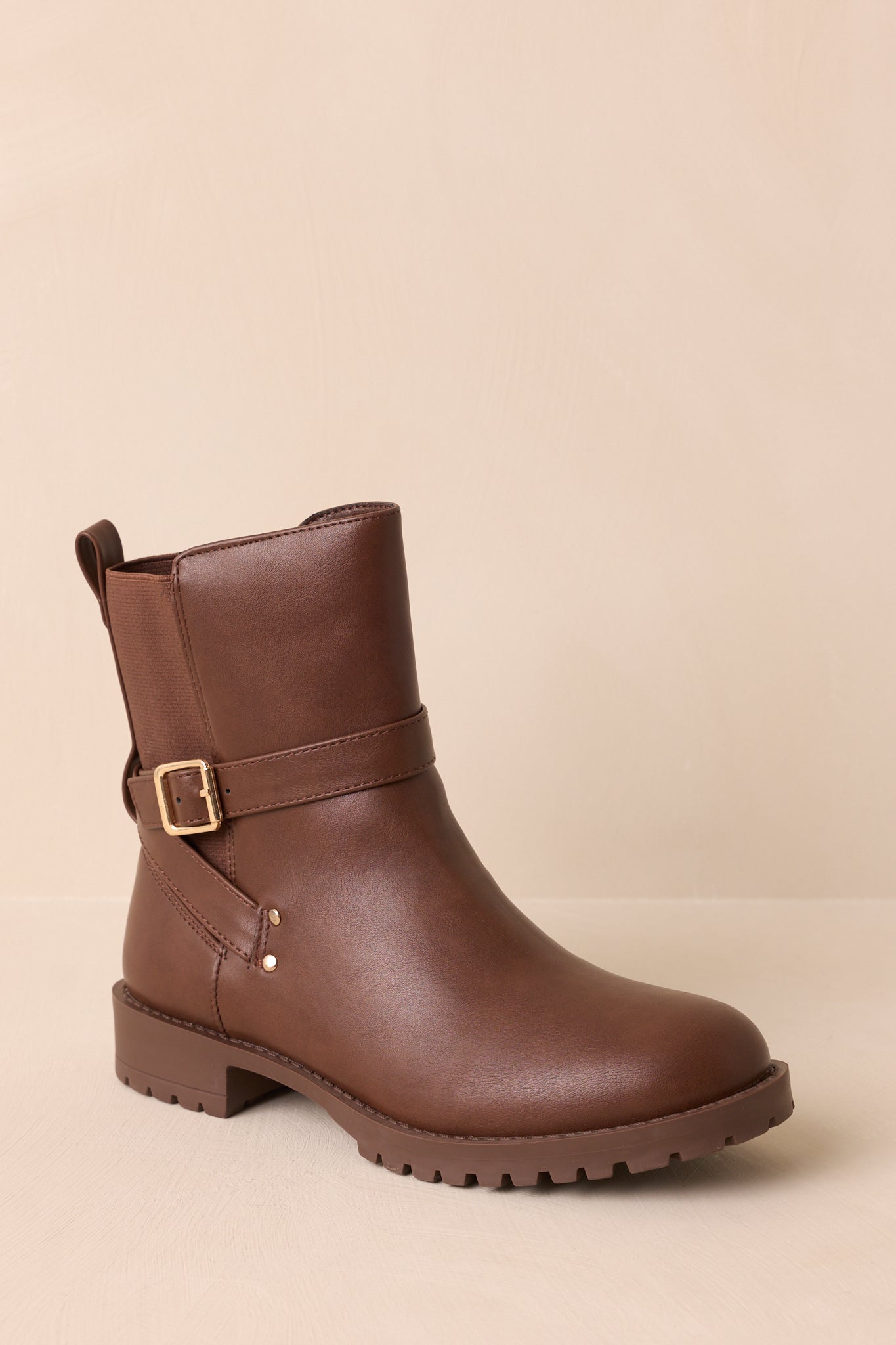 An angled front view highlighting rounded toes and sleek silhouette of the ankle boots.