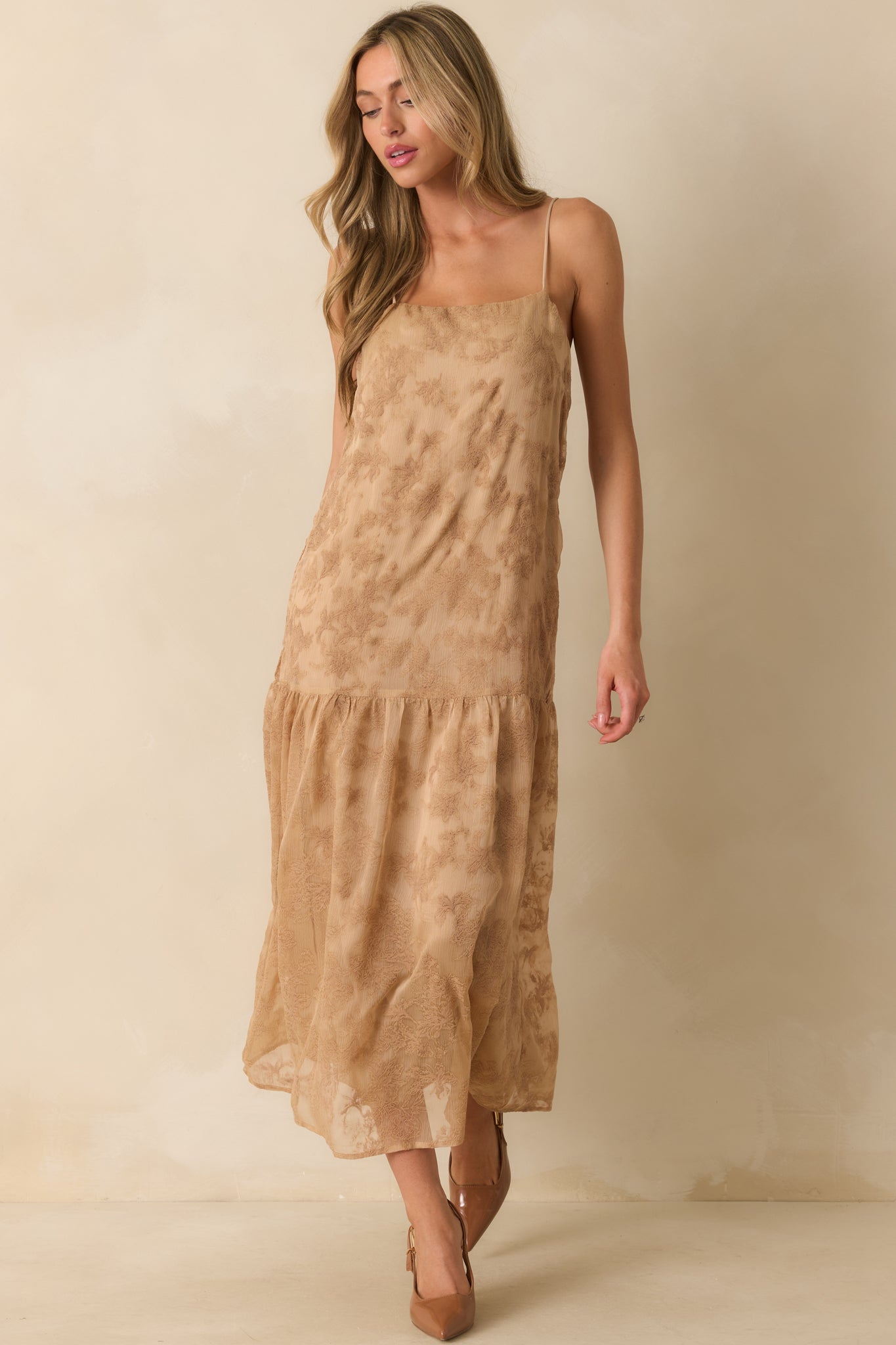 An angled front view showing the side seam and gentle movement of the gathered tiers.