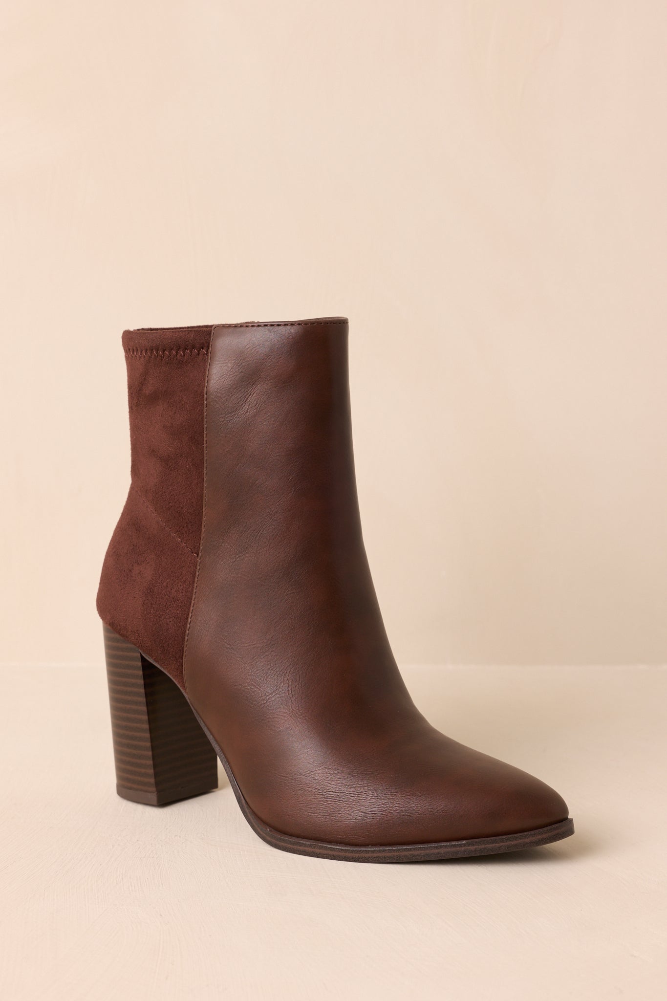 Angled view of the boots showcasing the inner side zipper closure and streamlined profile.