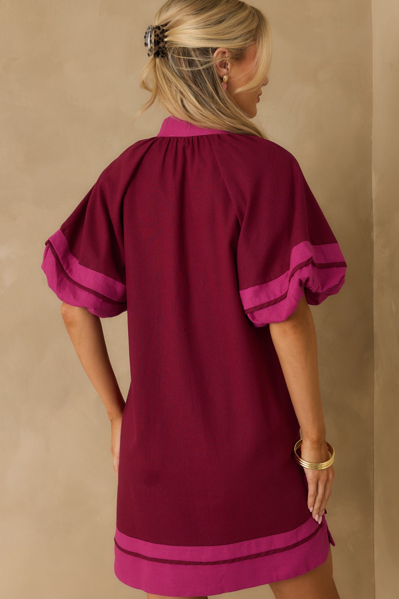A back view of the berry purple mini dress featuring a shift silhouette and full lining.