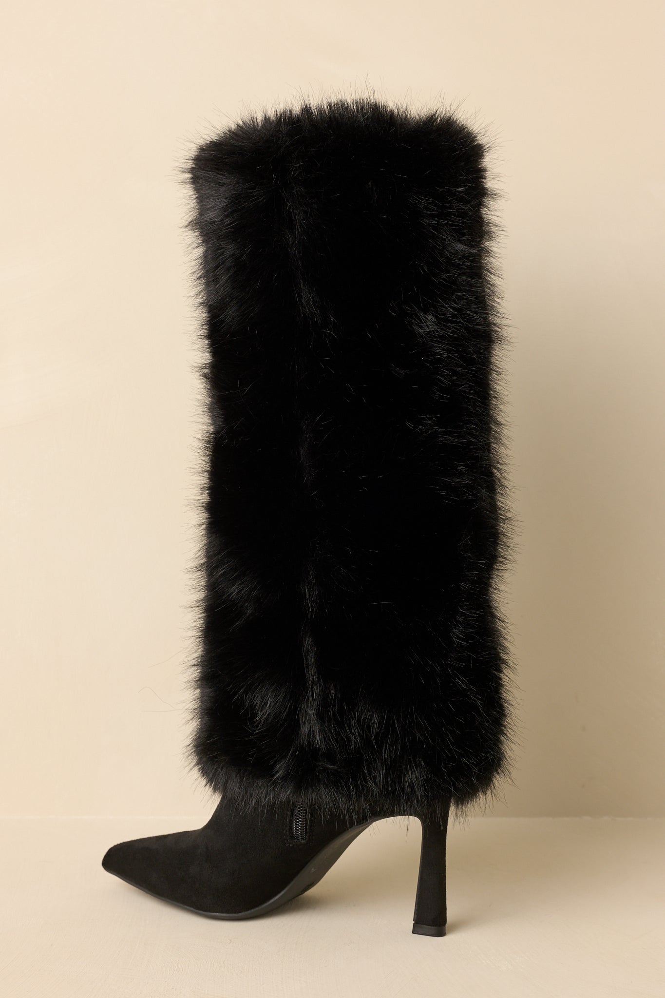 Back view of the black stiletto boots highlighting the plush faux fur shaft, slim high heel, and knee-high silhouette.