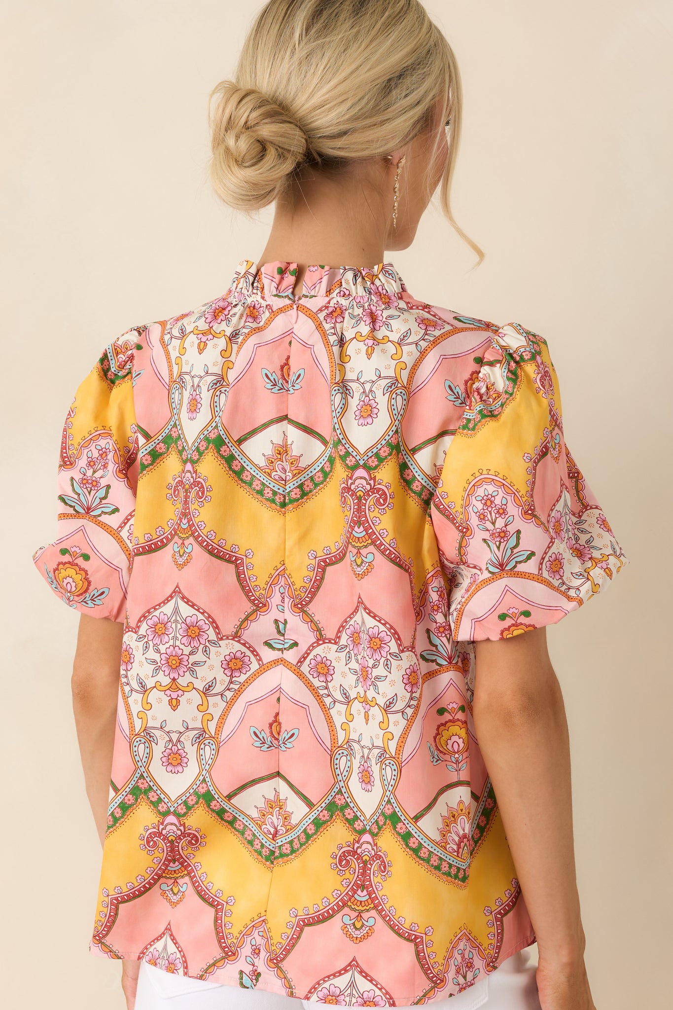 Pink and marigold print top from the back, featuring a concealed zipper closure, relaxed shape, and continuous ornamental print design.