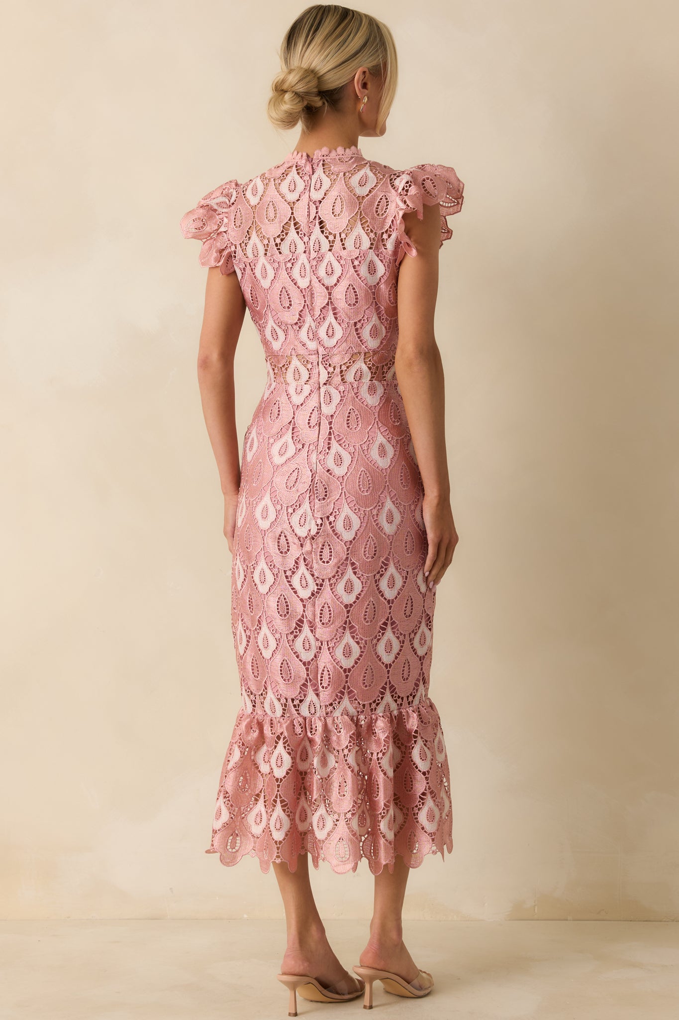 The back of the maxi dress shows the fitted lace bodice with a hidden zipper and flowing flounced skirt.