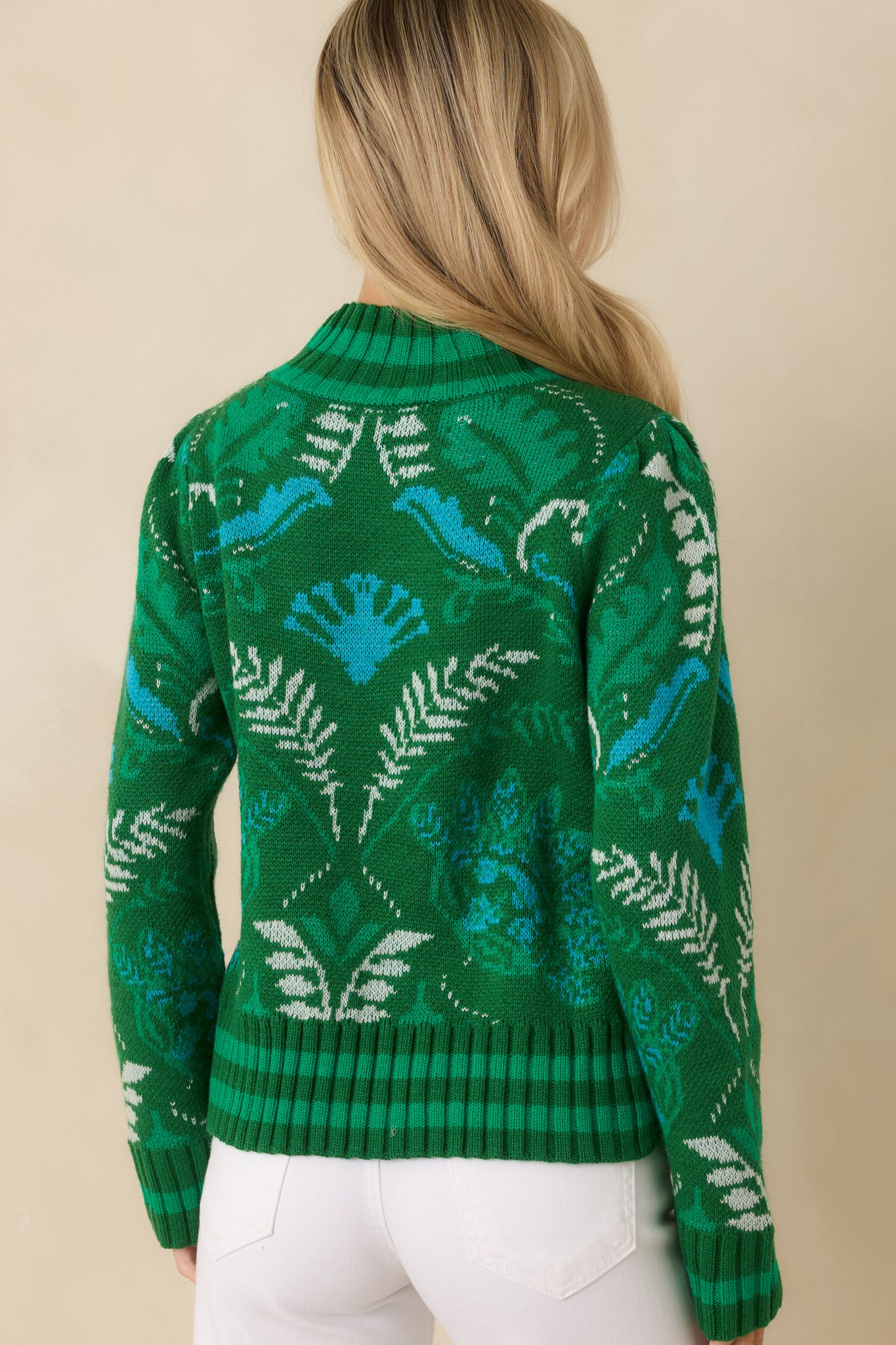 Back view of the green multi knit sweater highlighting the continuous botanical pattern and relaxed drape.