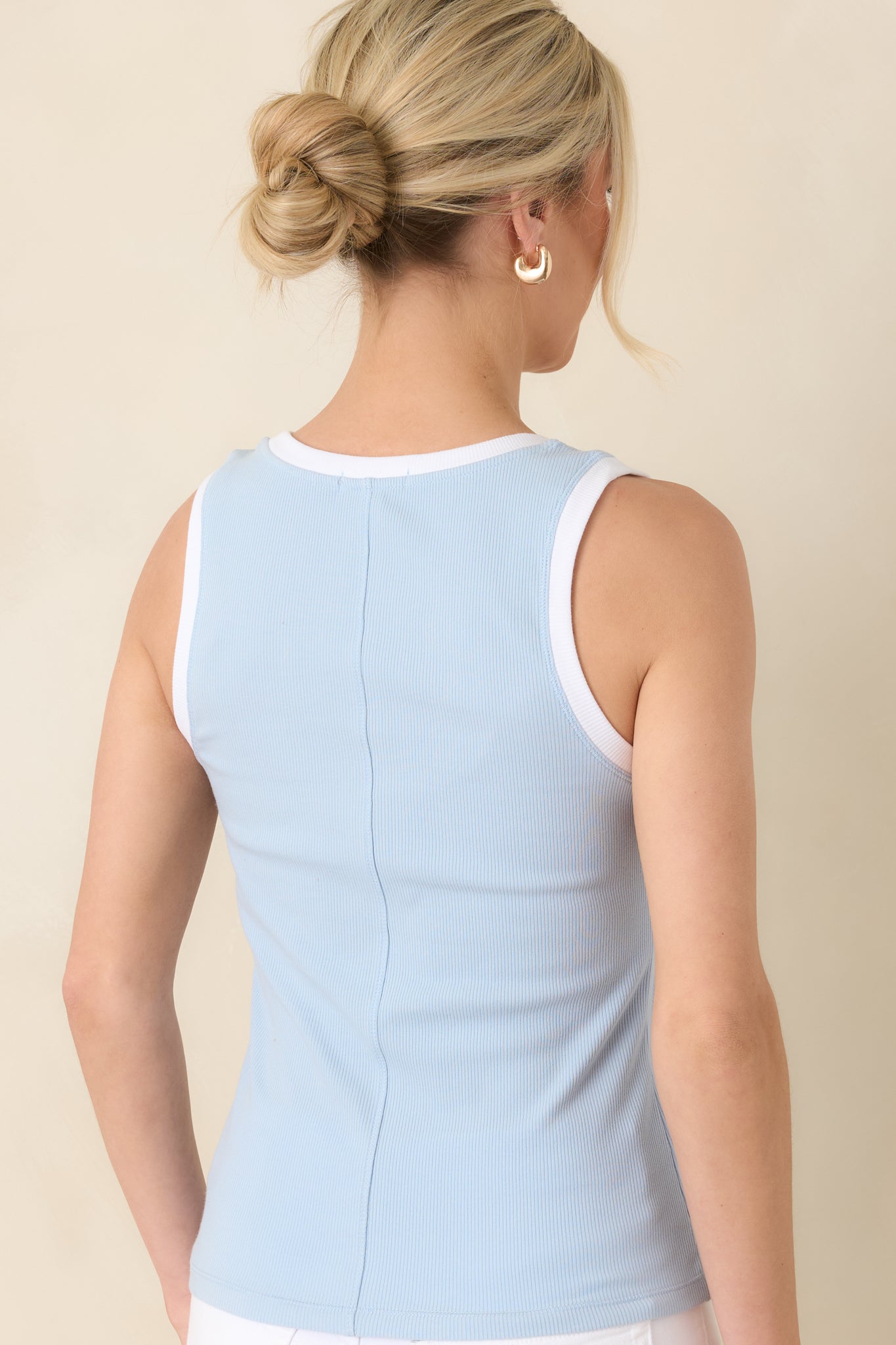Back view of the light blue sleeveless tank showcasing wide straps and clean straight hem for versatile styling.