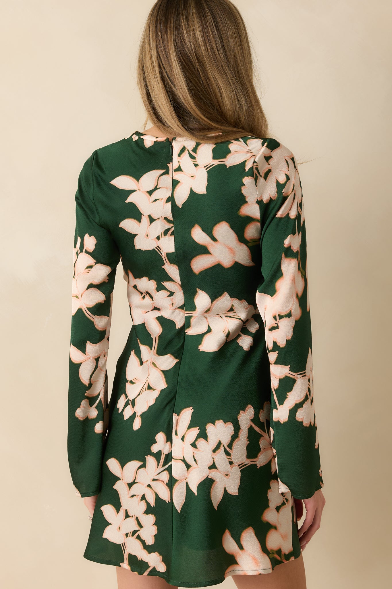 The back of the mini dress shows the flowing A-line silhouette, long sleeves, and fully lined satin interior.