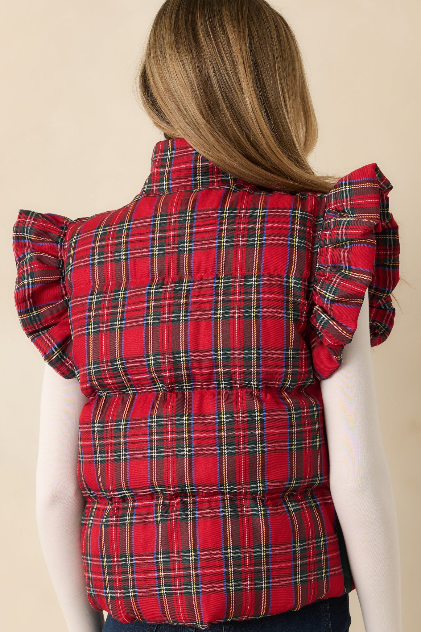 Back view of the red plaid puffer vest highlighting its quilted padding and structured shape.