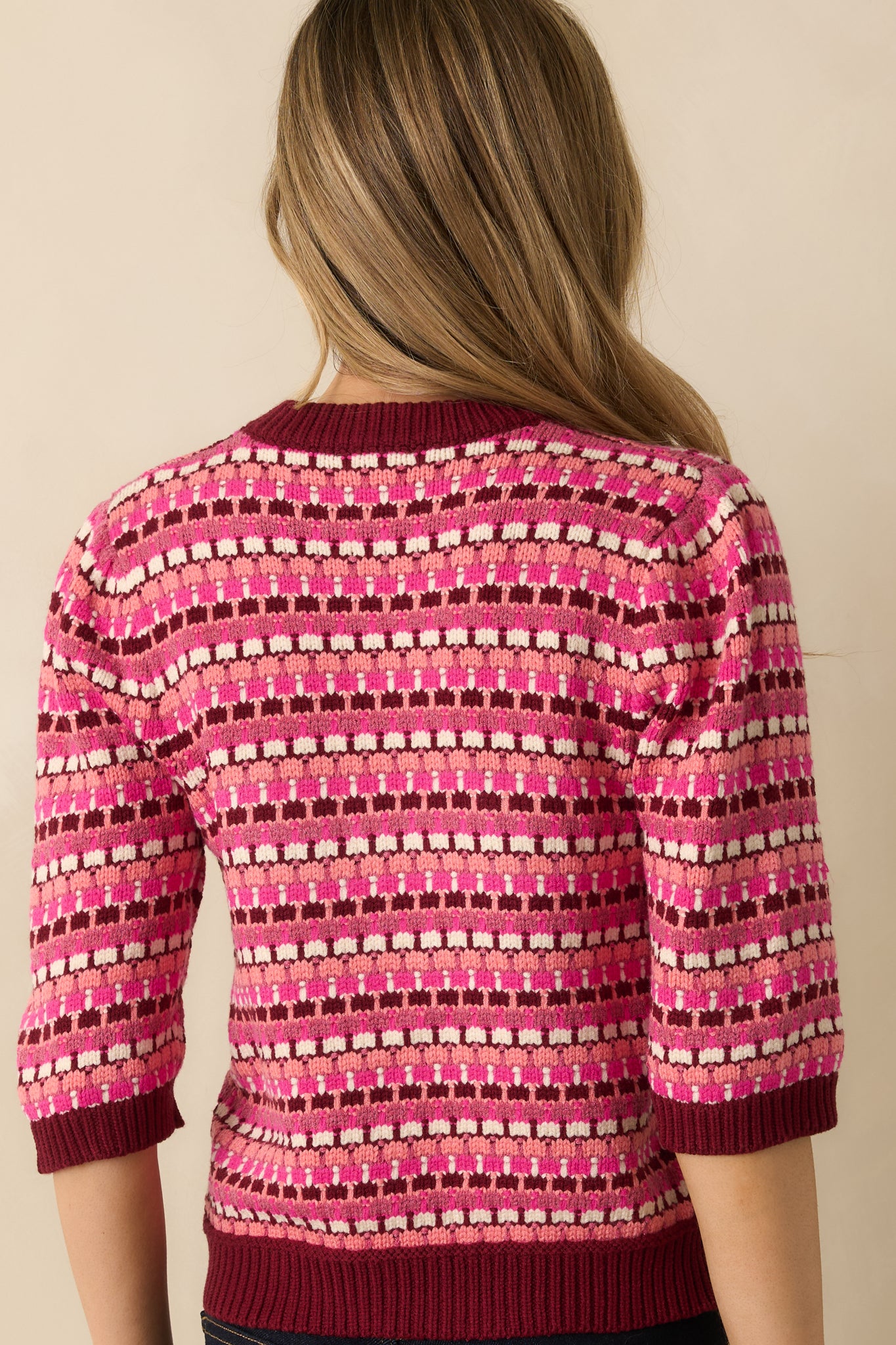 The back of the sweater shows the full striped pattern, soft medium-weight knit, and 3/4 sleeves with ribbed cuffs and hem.