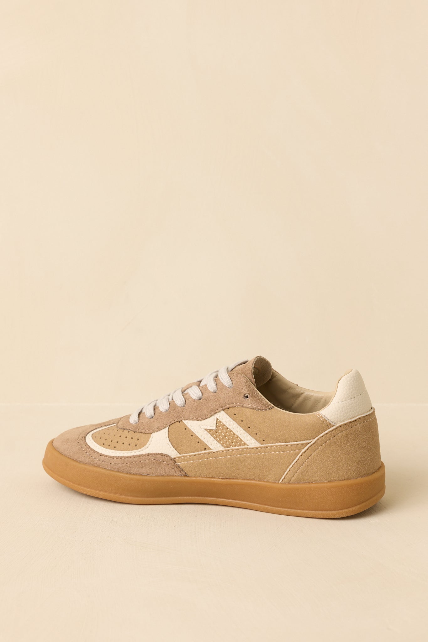 Back view of tan lace-up sneakers highlighting the heel structure, contrast paneling, and gum sole.