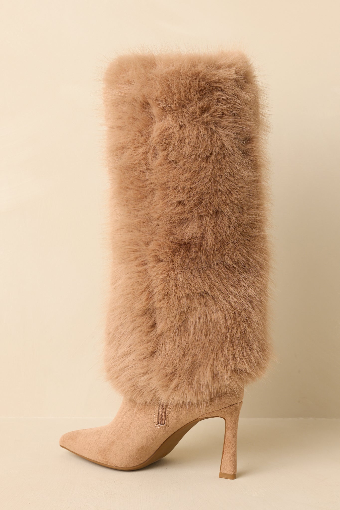 Back view of the tan stiletto boots highlighting the plush faux fur shaft, slim high heel, and knee-high silhouette.