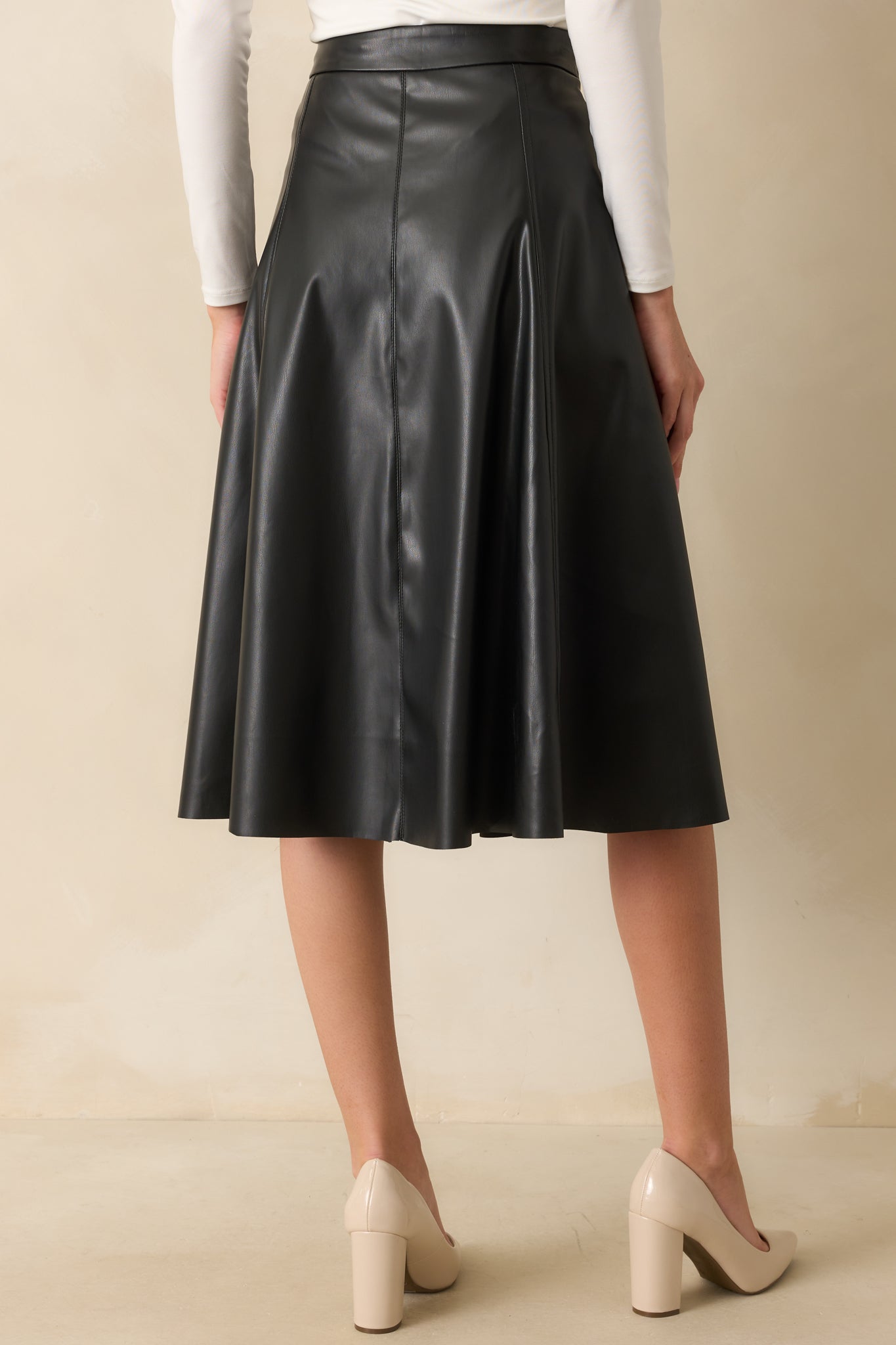 A back view of the A-line skirt highlighting the seam construction and clean finish of the faux leather.