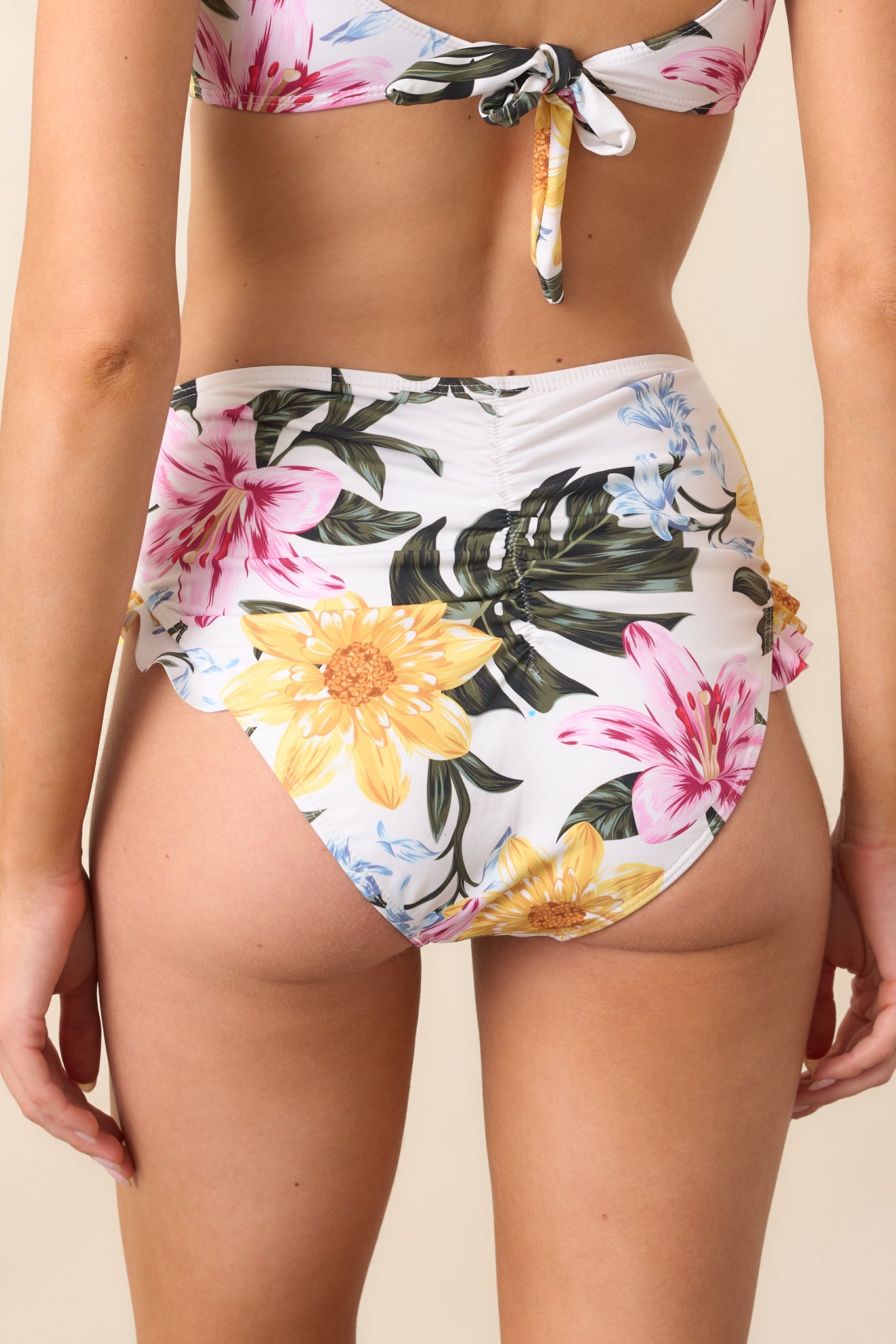 A back view of the bikini bottoms, emphasizing the slightly cheeky design, high-waisted fit, and ruffle detailing.