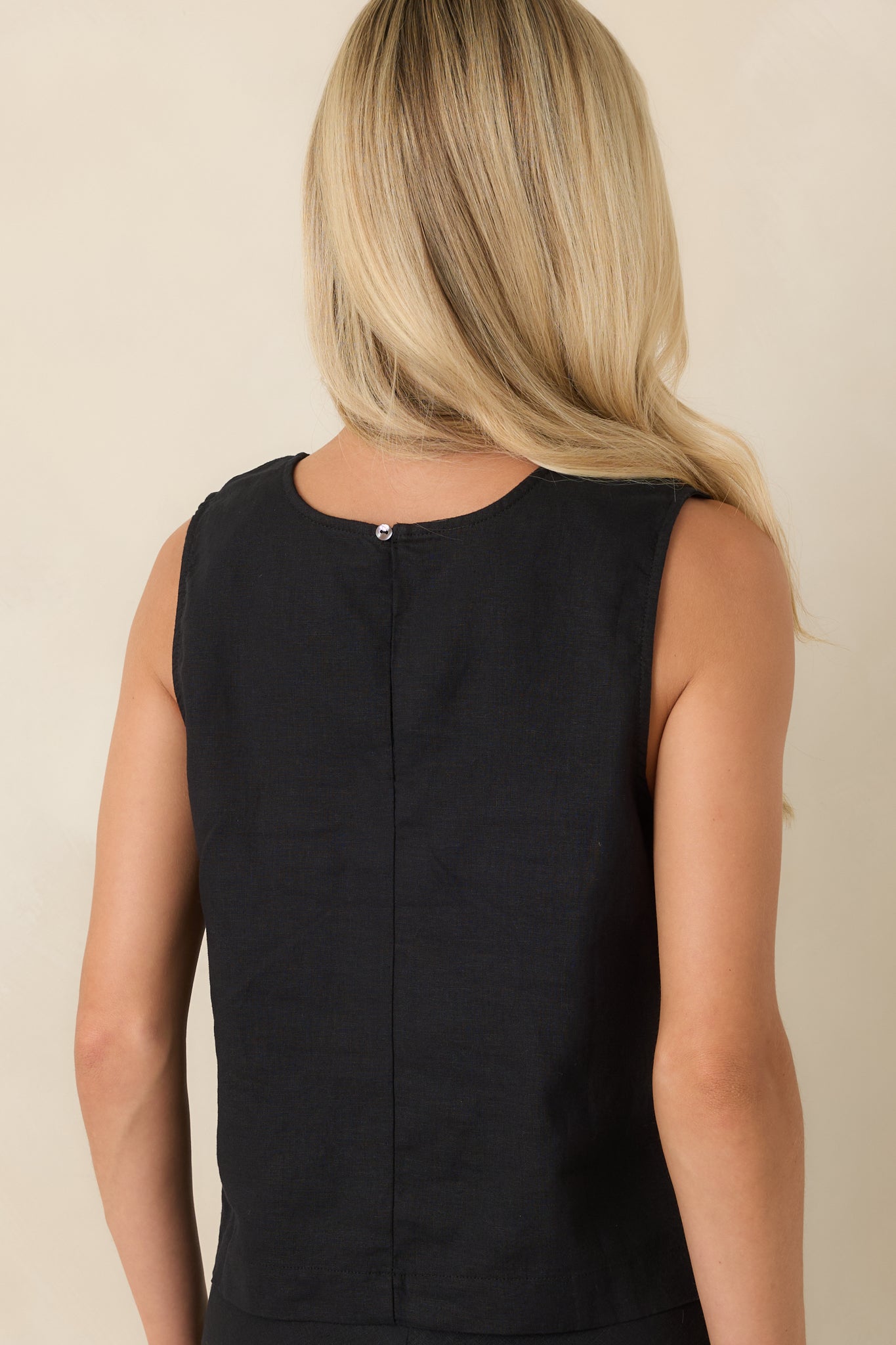 Back view of the black linen blend top featuring a subtle keyhole detail and boxy silhouette.