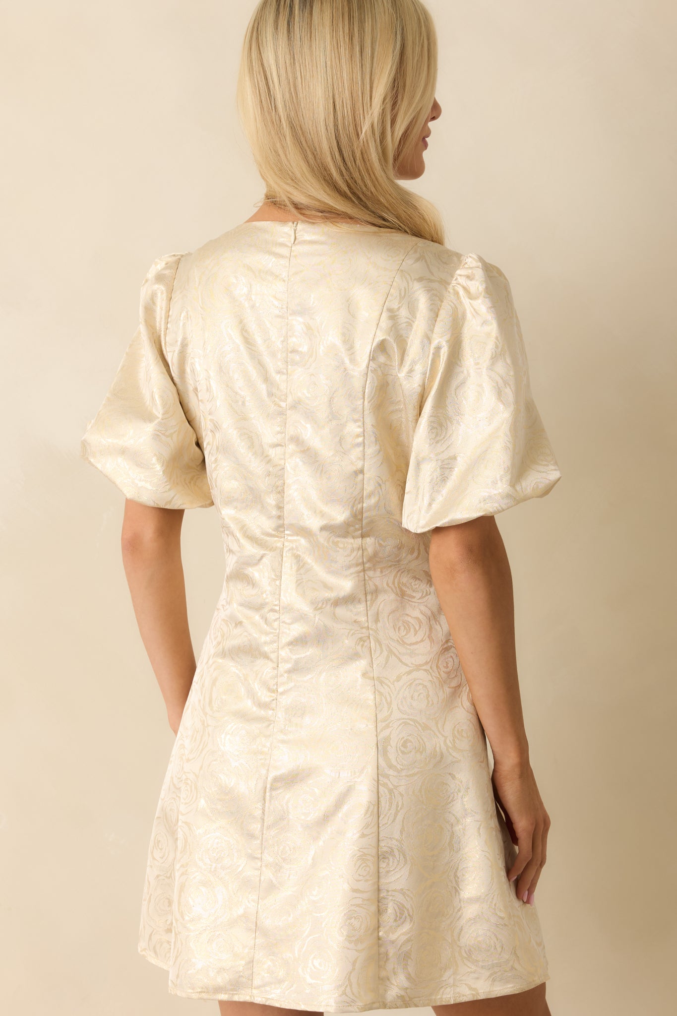 Back view of the champagne floral jacquard mini dress featuring the concealed zipper and smooth lining.