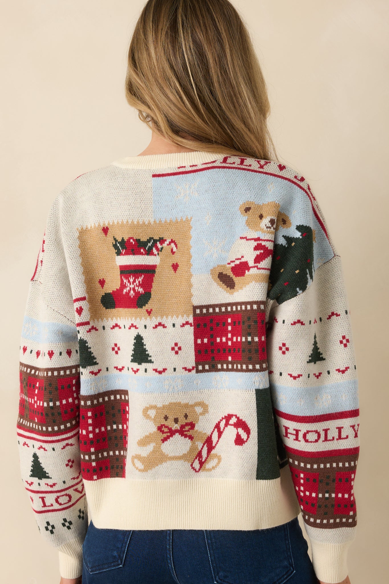 Back view of the Christmas sweater showing its relaxed drape and continued holiday patchwork design.