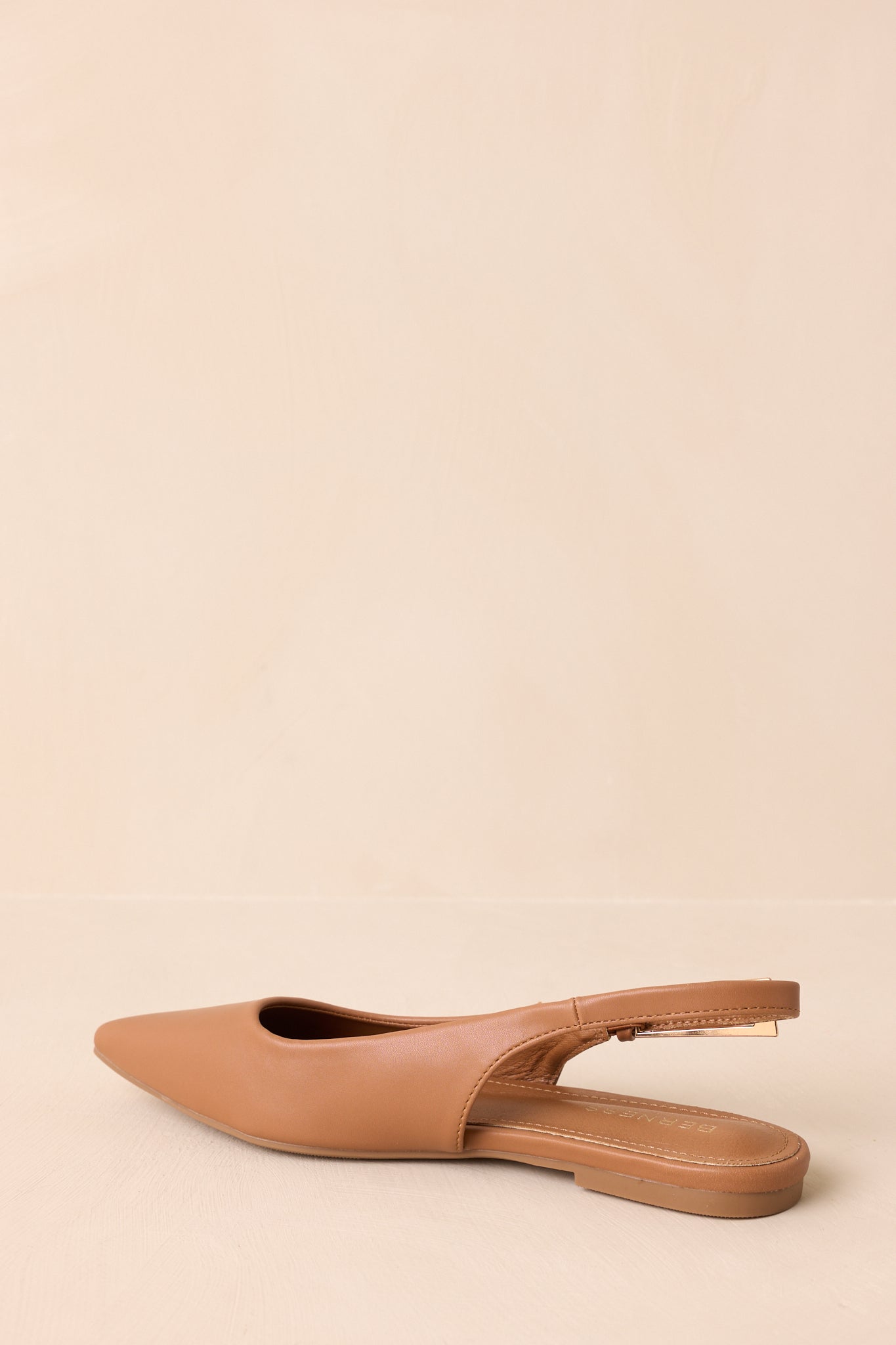 Back view of the flats showing the closed heel, slingback strap, and flat outsole.