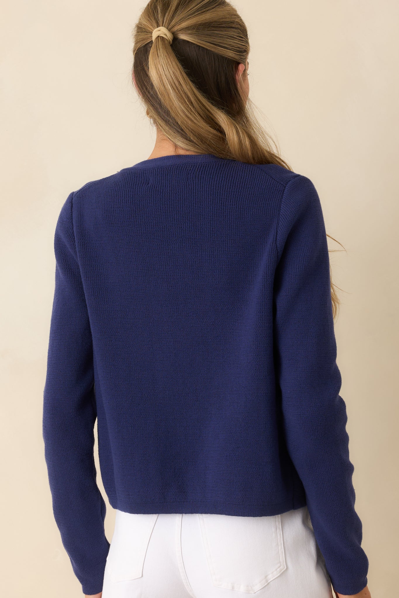 Back view of the cotton knit cardigan featuring a clean silhouette, long sleeves, and soft textured knit fabric.