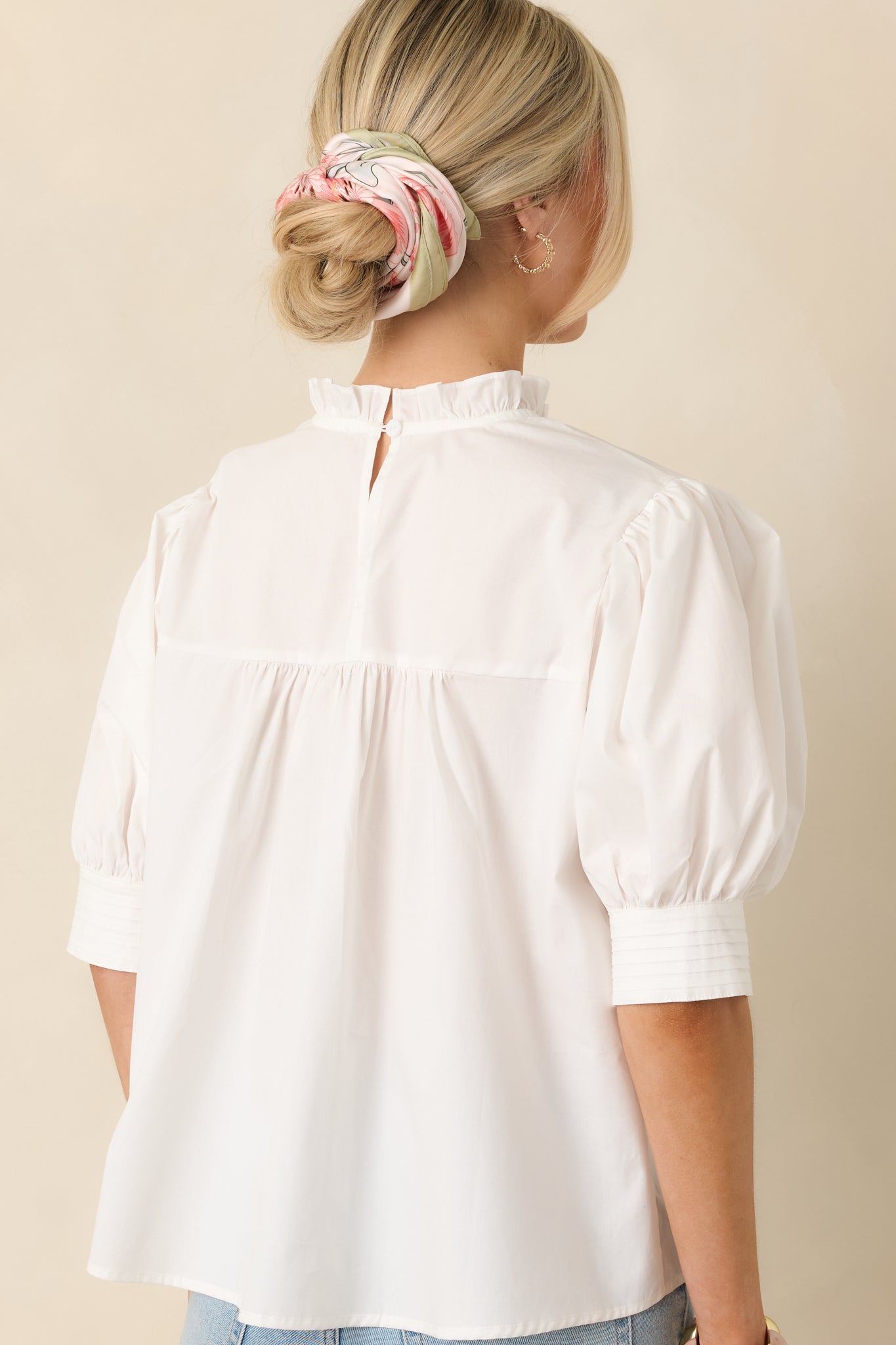 Back view of the blouse displaying the keyhole button closure and smooth back panel.