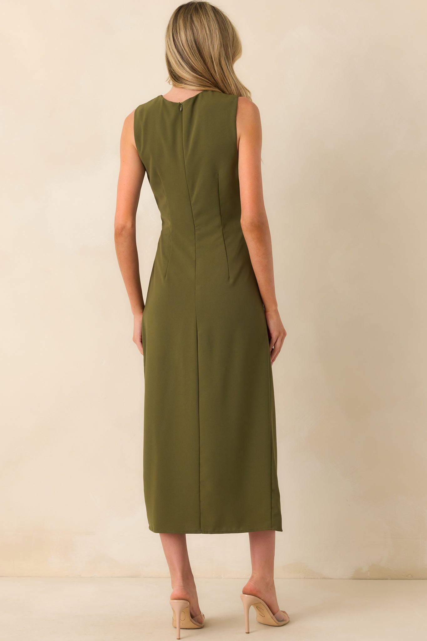 The back view of the olive green dress displaying the smooth, uninterrupted fabric and sleeveless cut from behind.