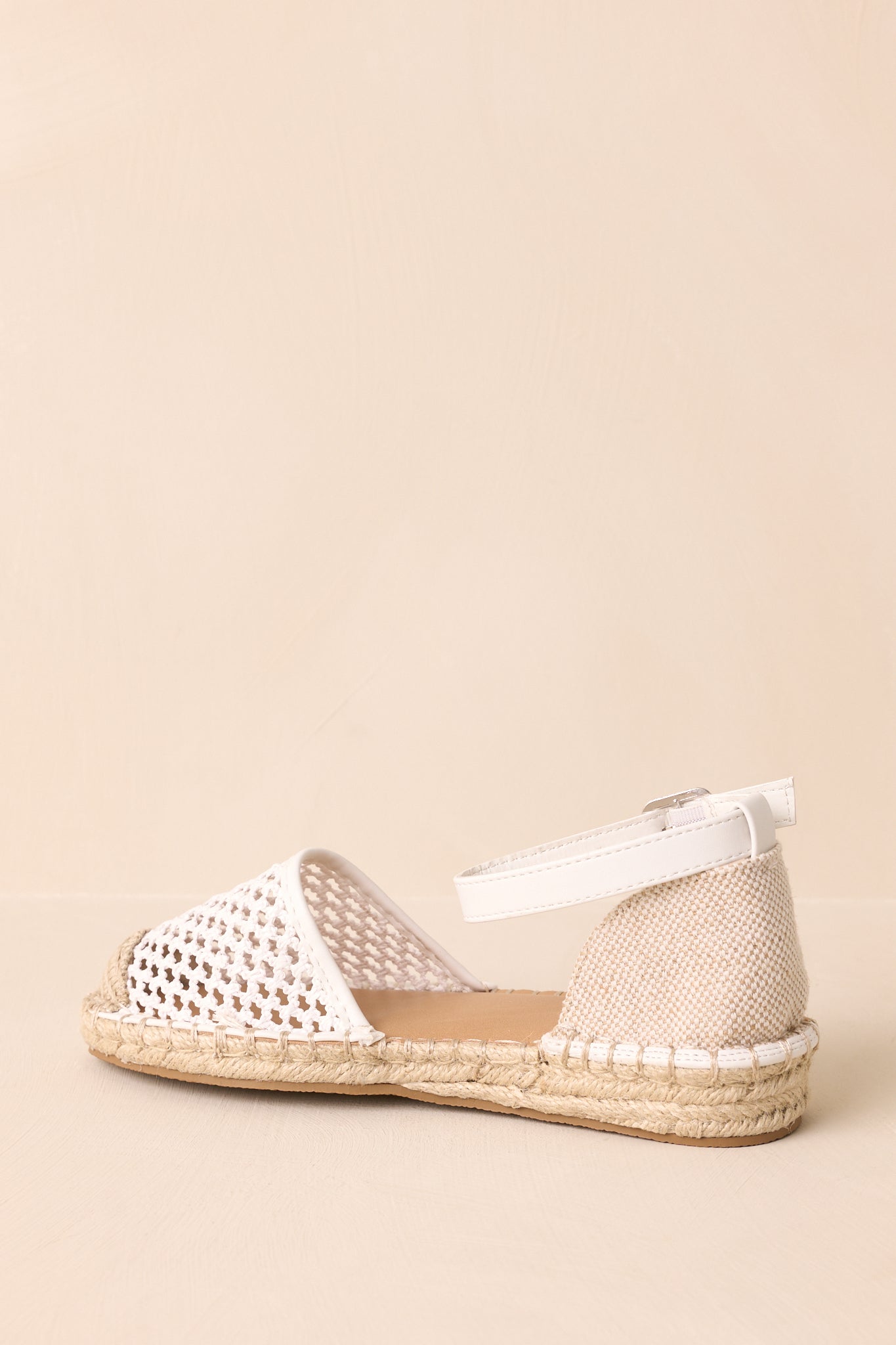 Back view showing the ankle strap, heel area, and flat braided jute sole.