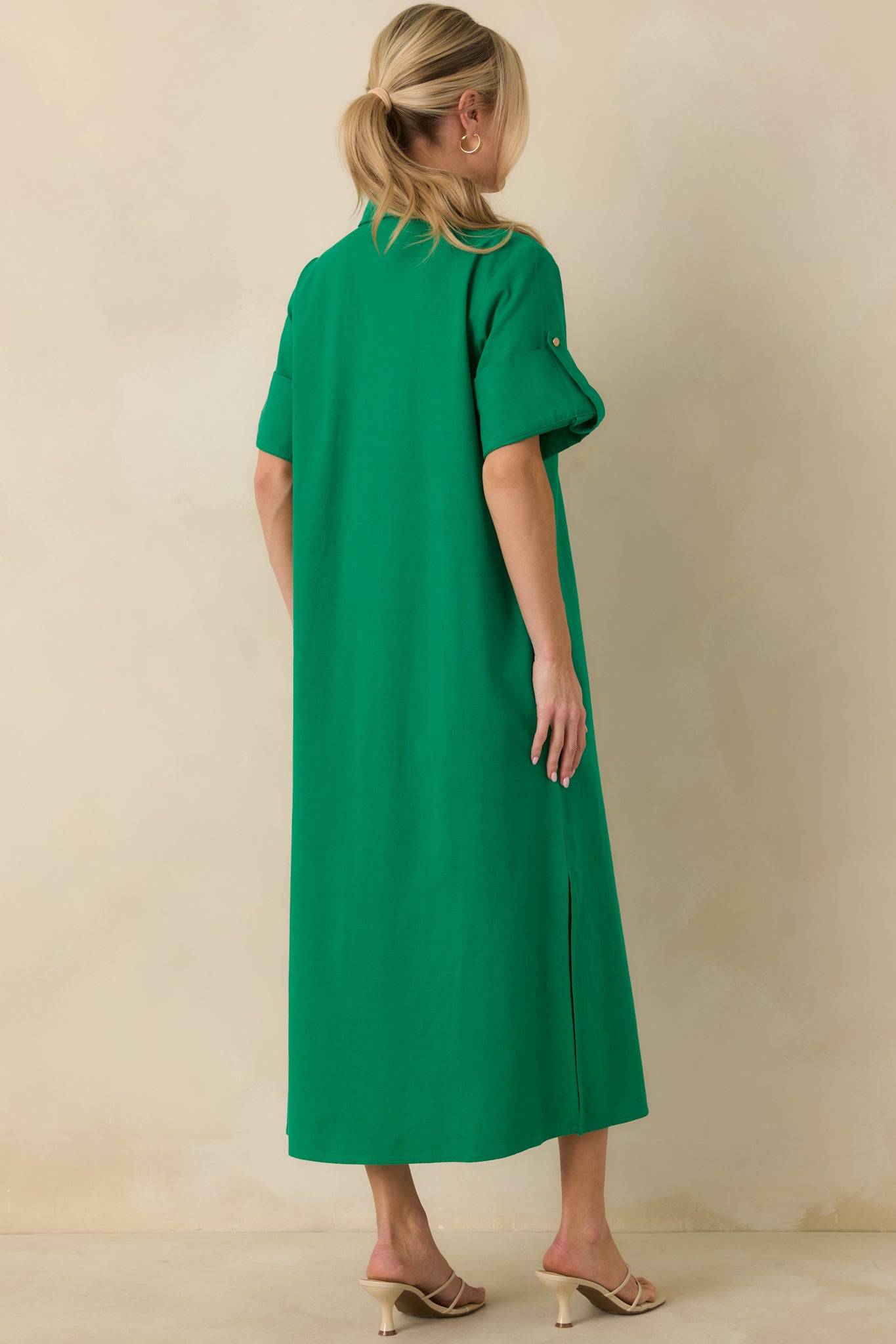 Back view of green midi shirt dress highlighting long sleeves, relaxed straight silhouette, and smooth cotton drape.