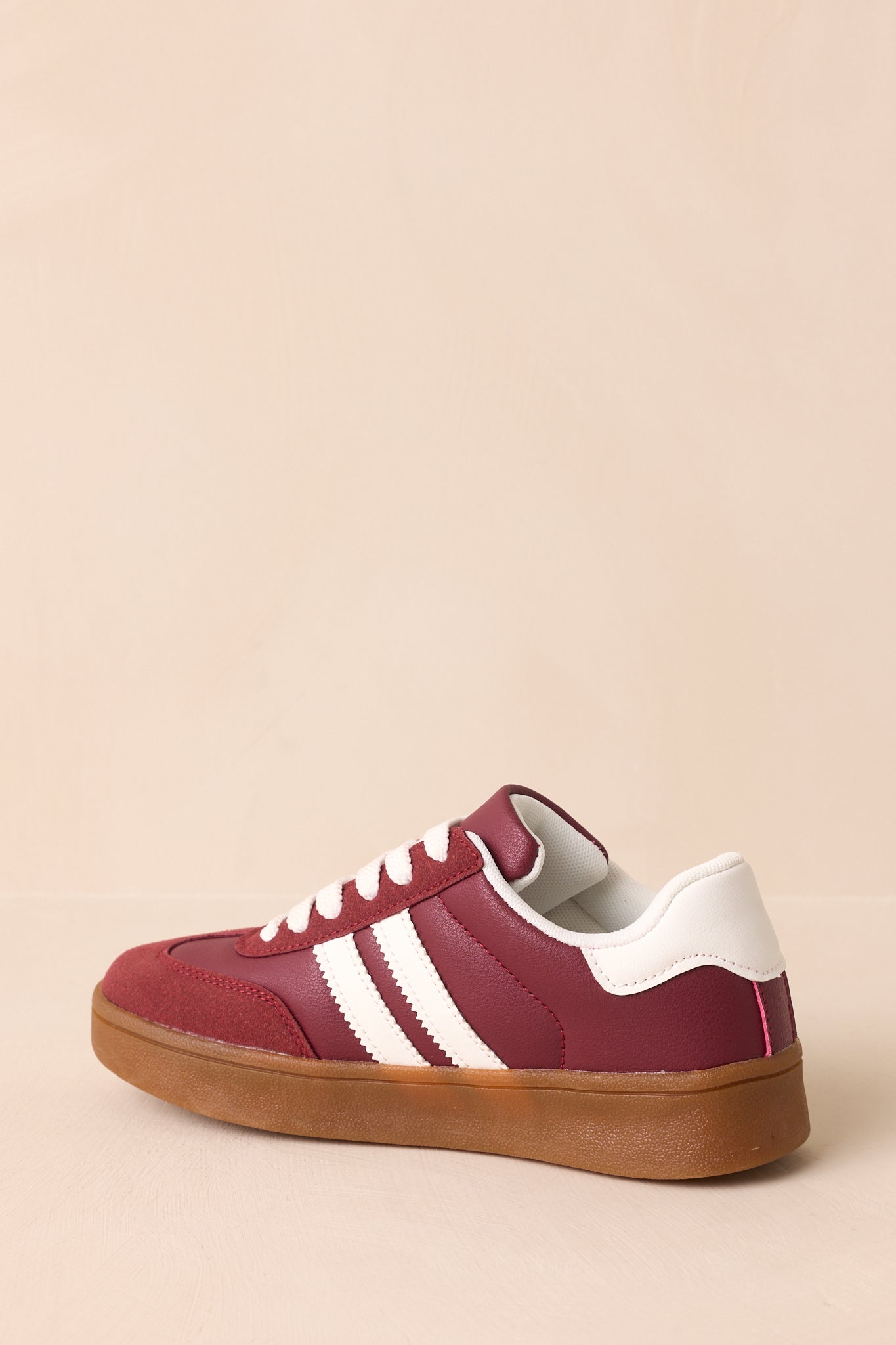 Back view of the sneaker highlighting the heel panel design and gum rubber sole extending along the back.