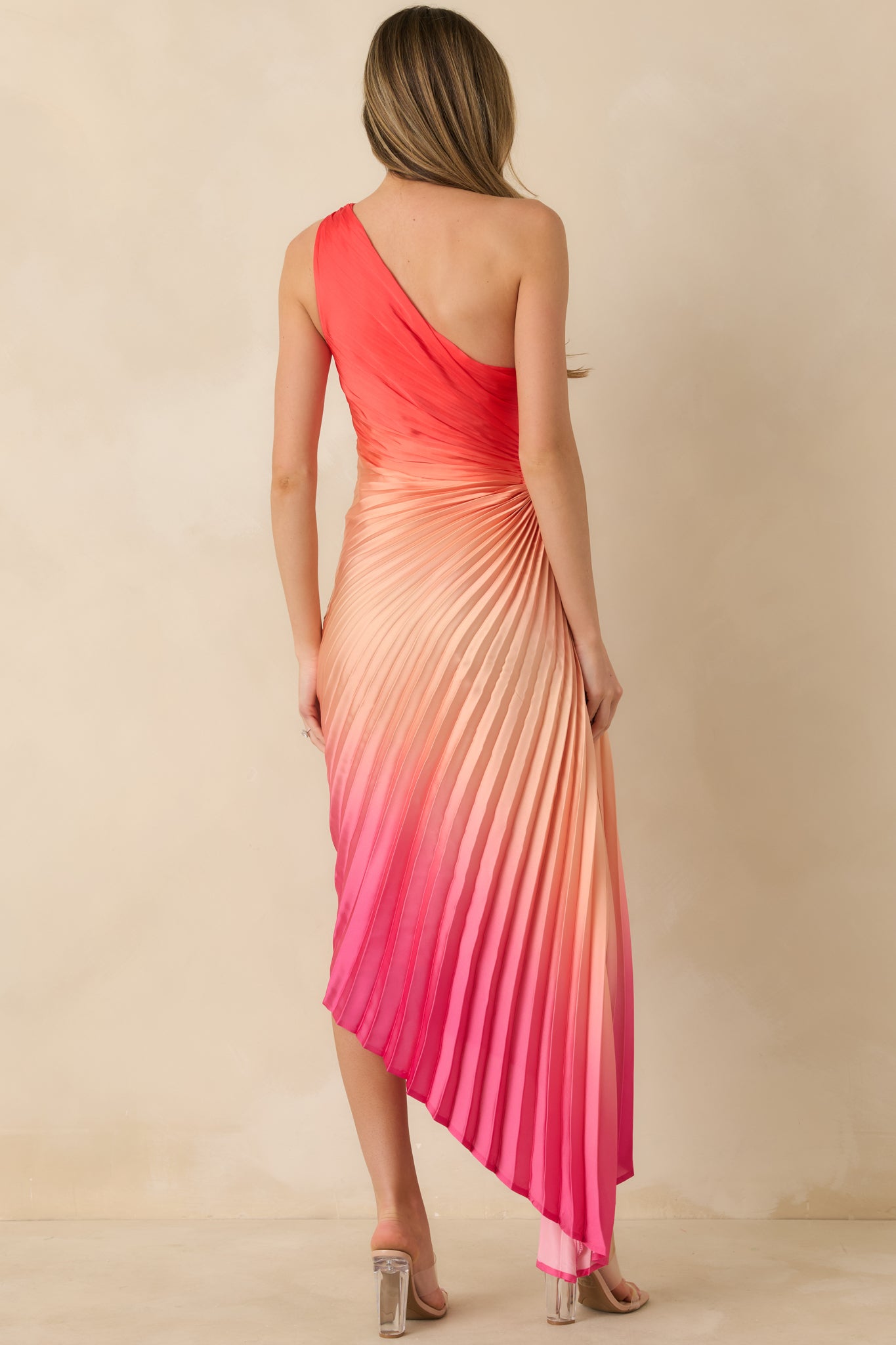 Back view of the coral ombre maxi dress highlighting the smooth pleated skirt, full lining, and concealed zipper closure.