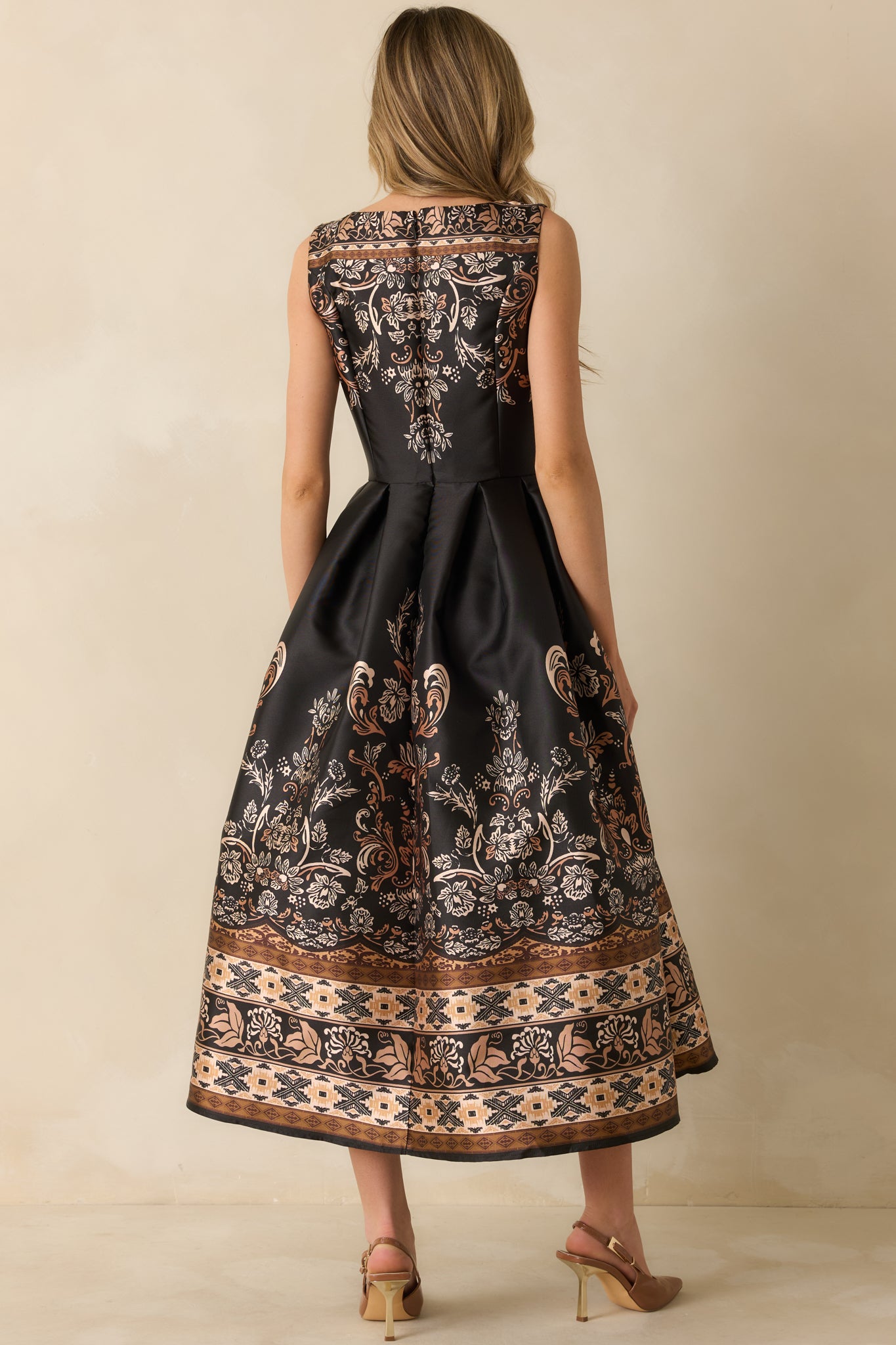 Back view showing the hidden back zipper closure, full lining, and structured finish of the dress.