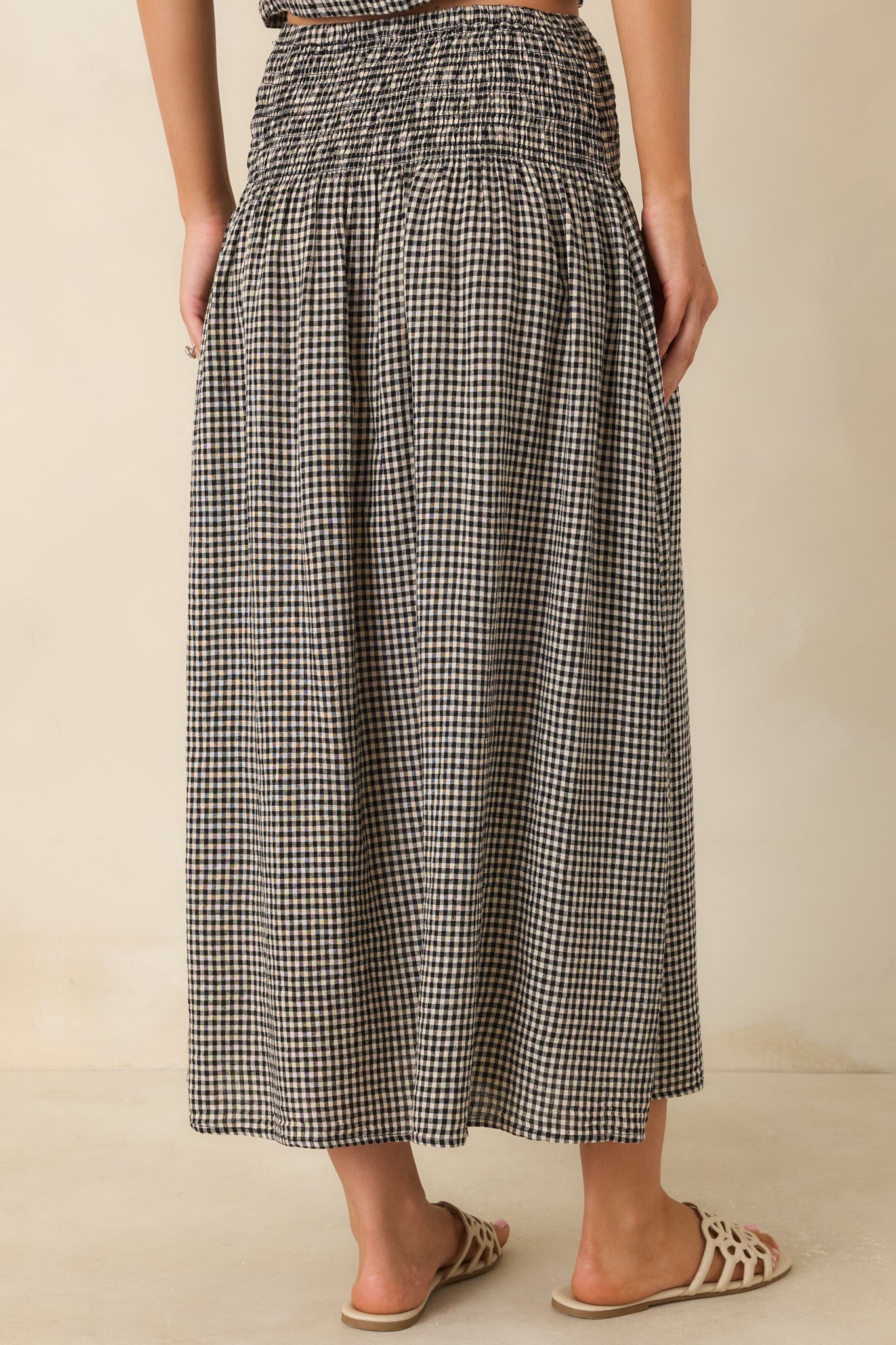 Back view of the flowing linen blend maxi skirt featuring a full draped silhouette.