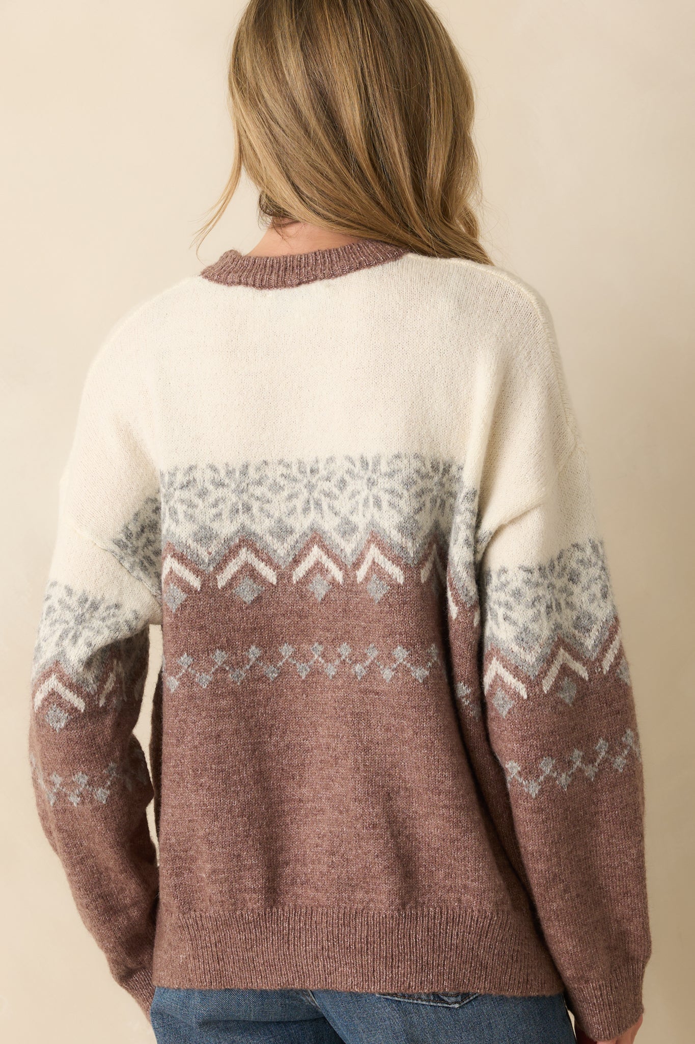 Rear view of the mauve sweater showing the long sleeves, relaxed silhouette, and allover Fair Isle pattern.