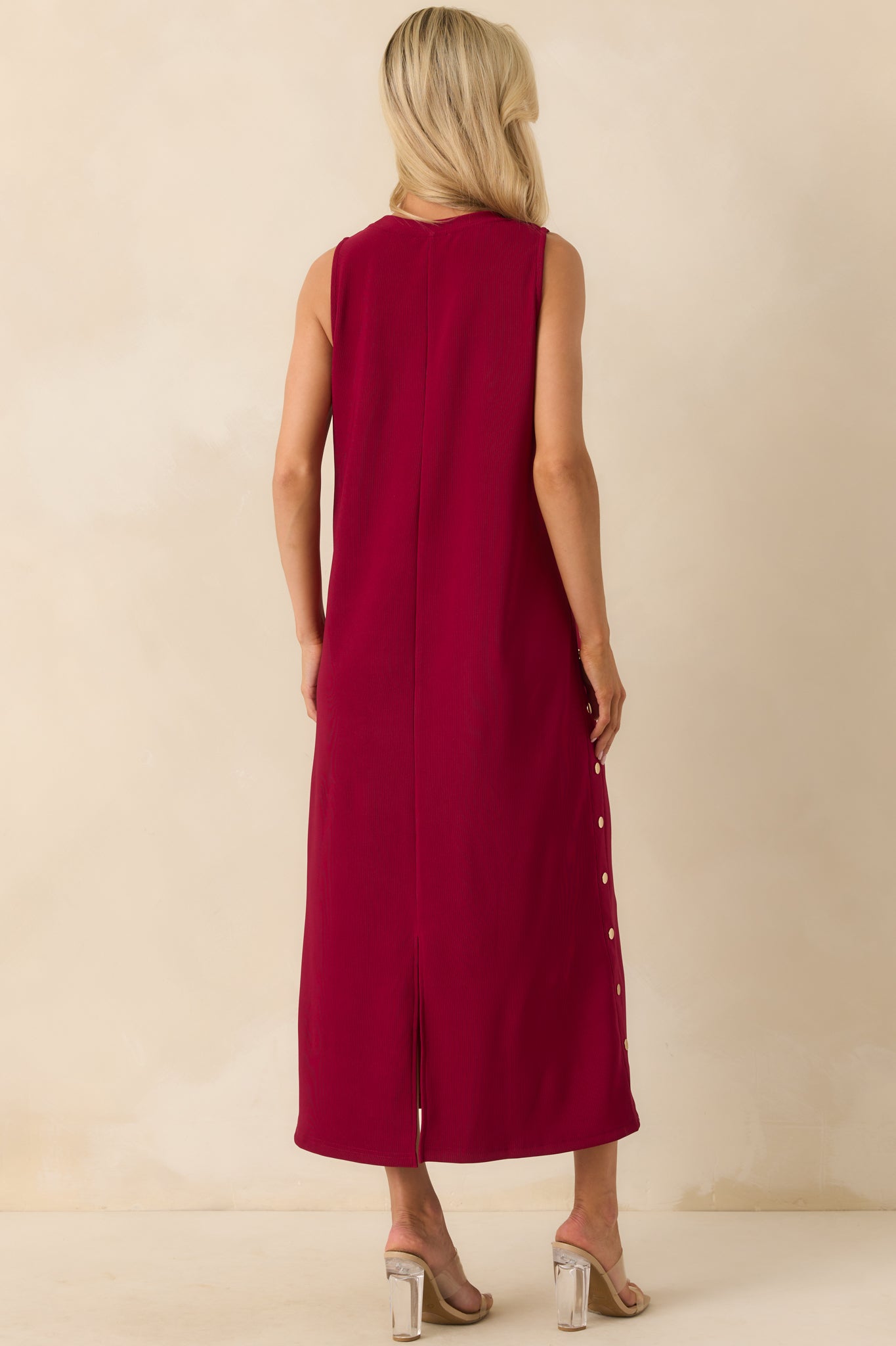Back view of the maxi dress showing the center back seam and back vent slit for ease of movement.