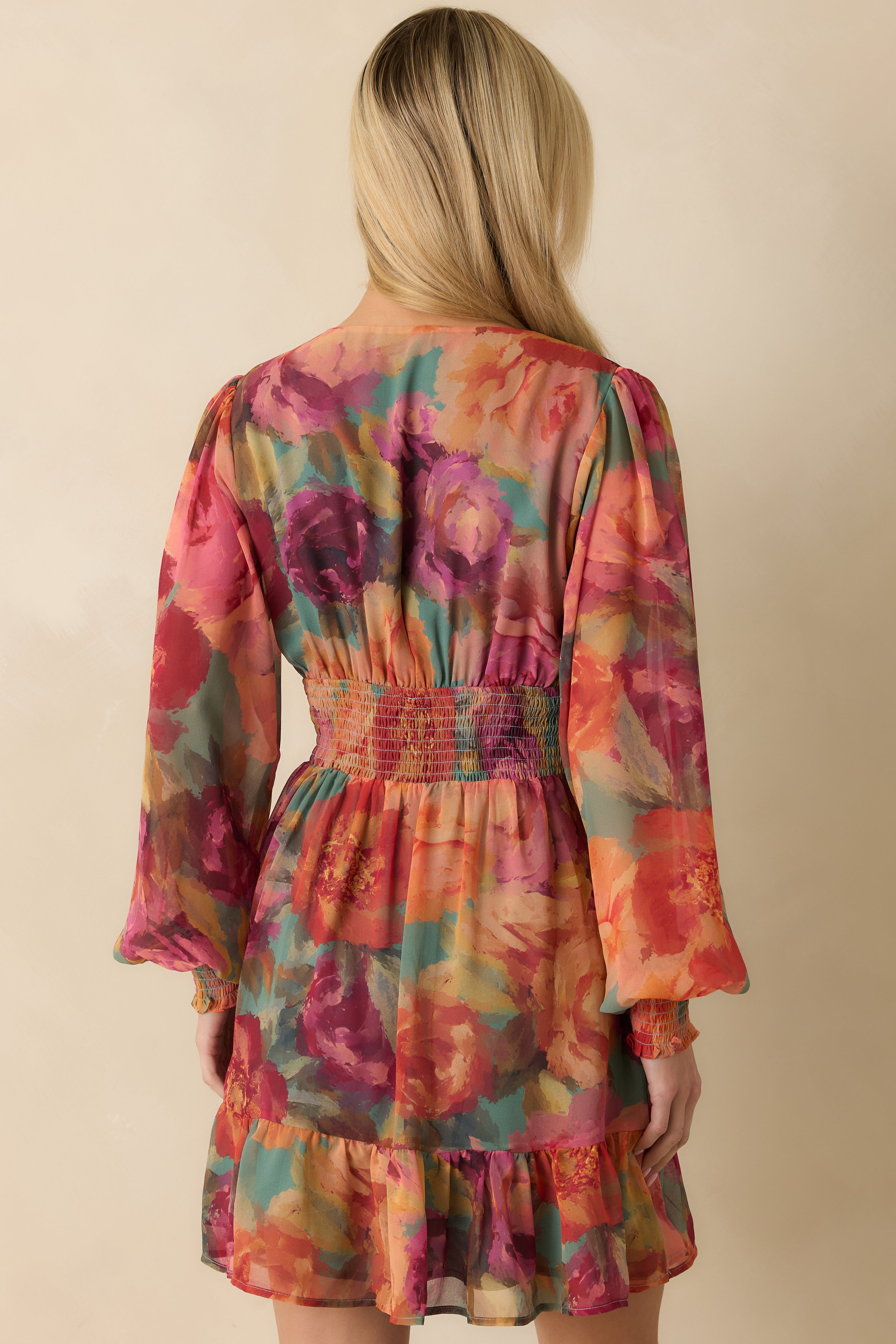 Back view of the mini dress showing the full lining, smocked waistband, and tiered hem detail.