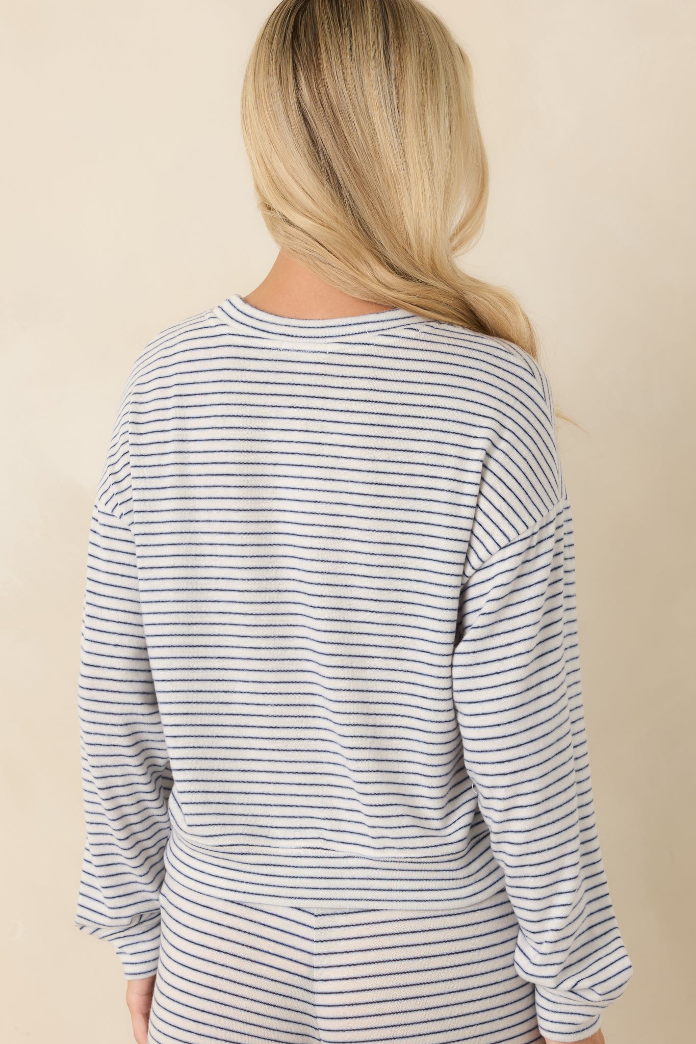 Back view of the navy striped sweater pullover highlighting the relaxed fit and dropped shoulders.