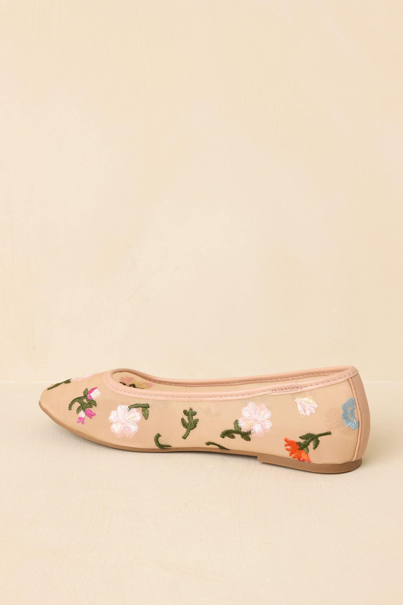 Back view of nude mesh ballet flats highlighting flat sole, soft structure, and embroidered detail wrapping around