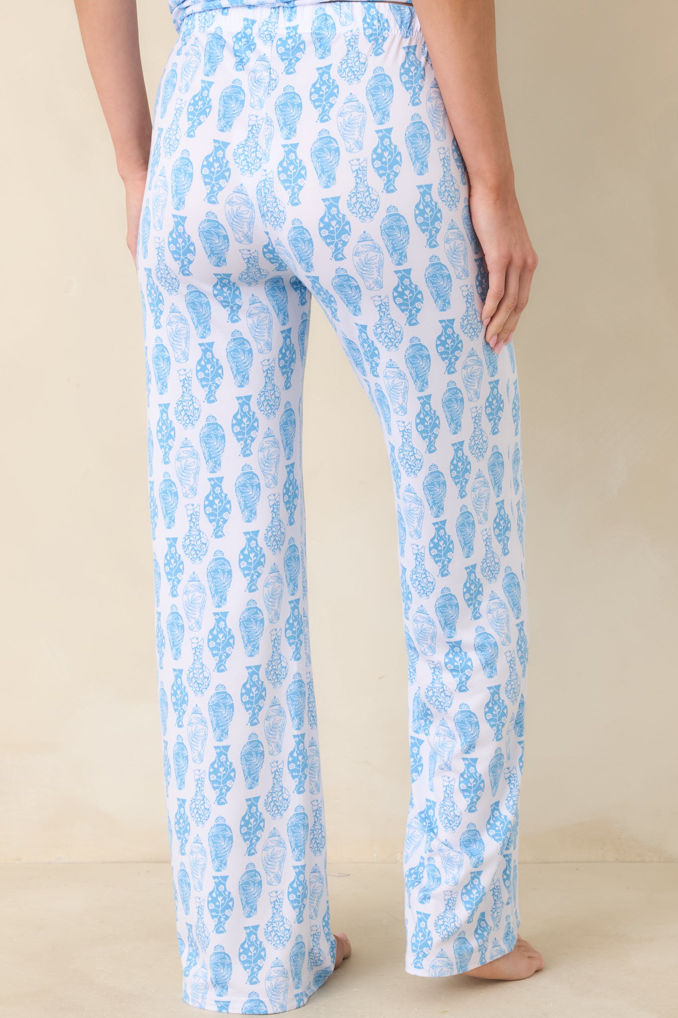 Back view of blue and white pajama pants with relaxed straight-leg silhouette, elastic waistband, and subtle print alignment.