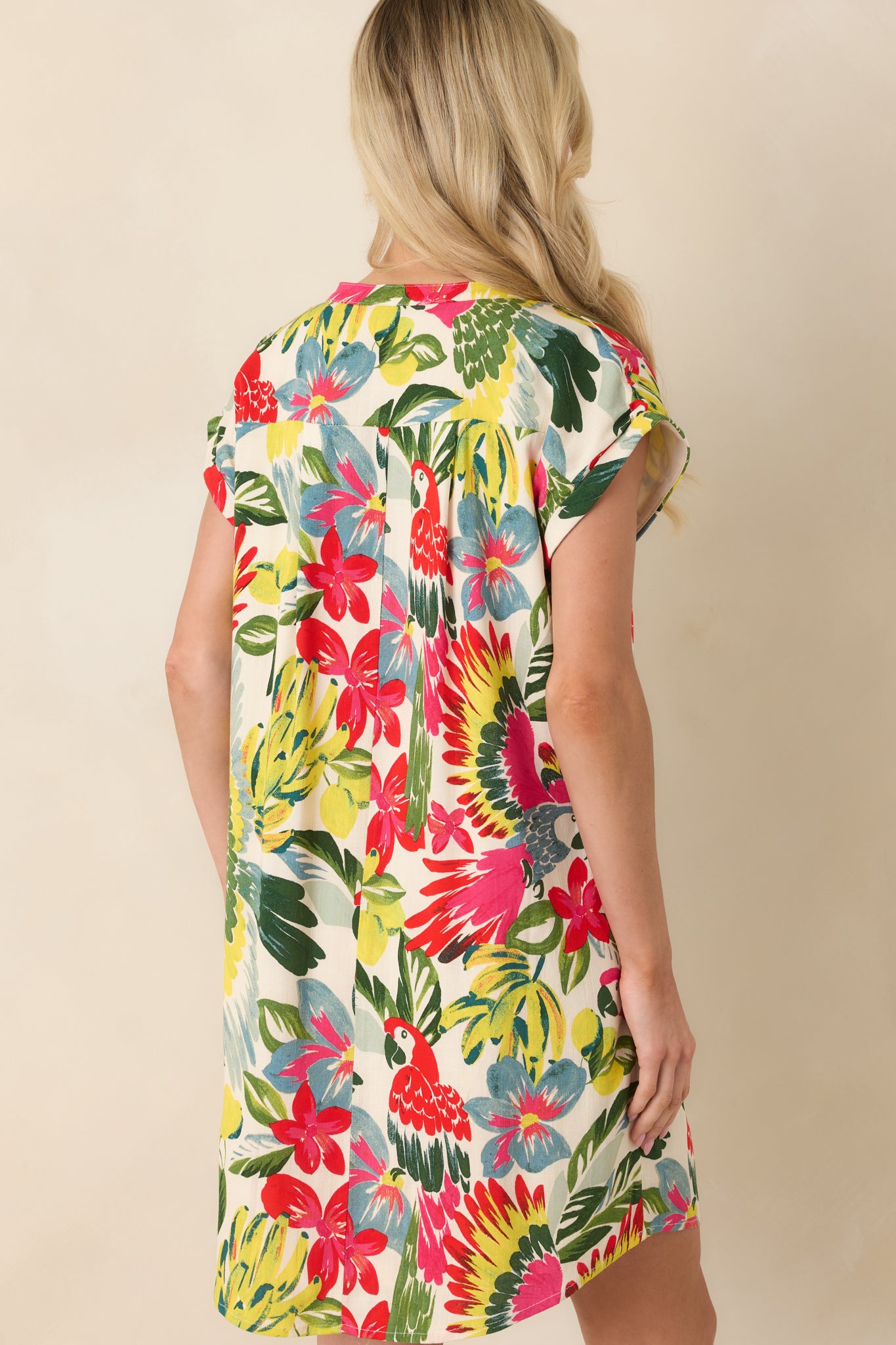 Back view of red tropical print shift mini dress showing relaxed silhouette and smooth drape of lightweight fabric