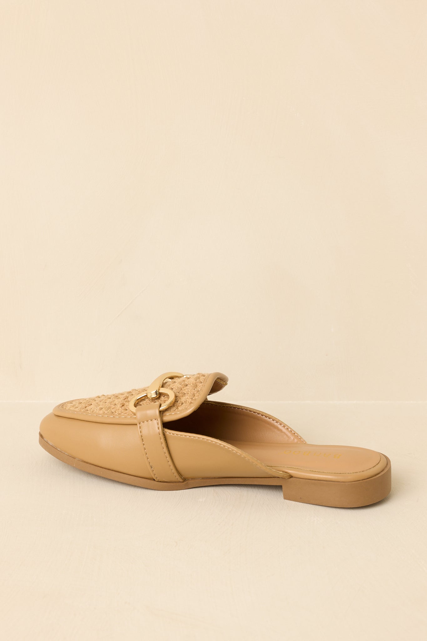 Back view of tan mule loafers highlighting open-back design and clean, minimal heel structure