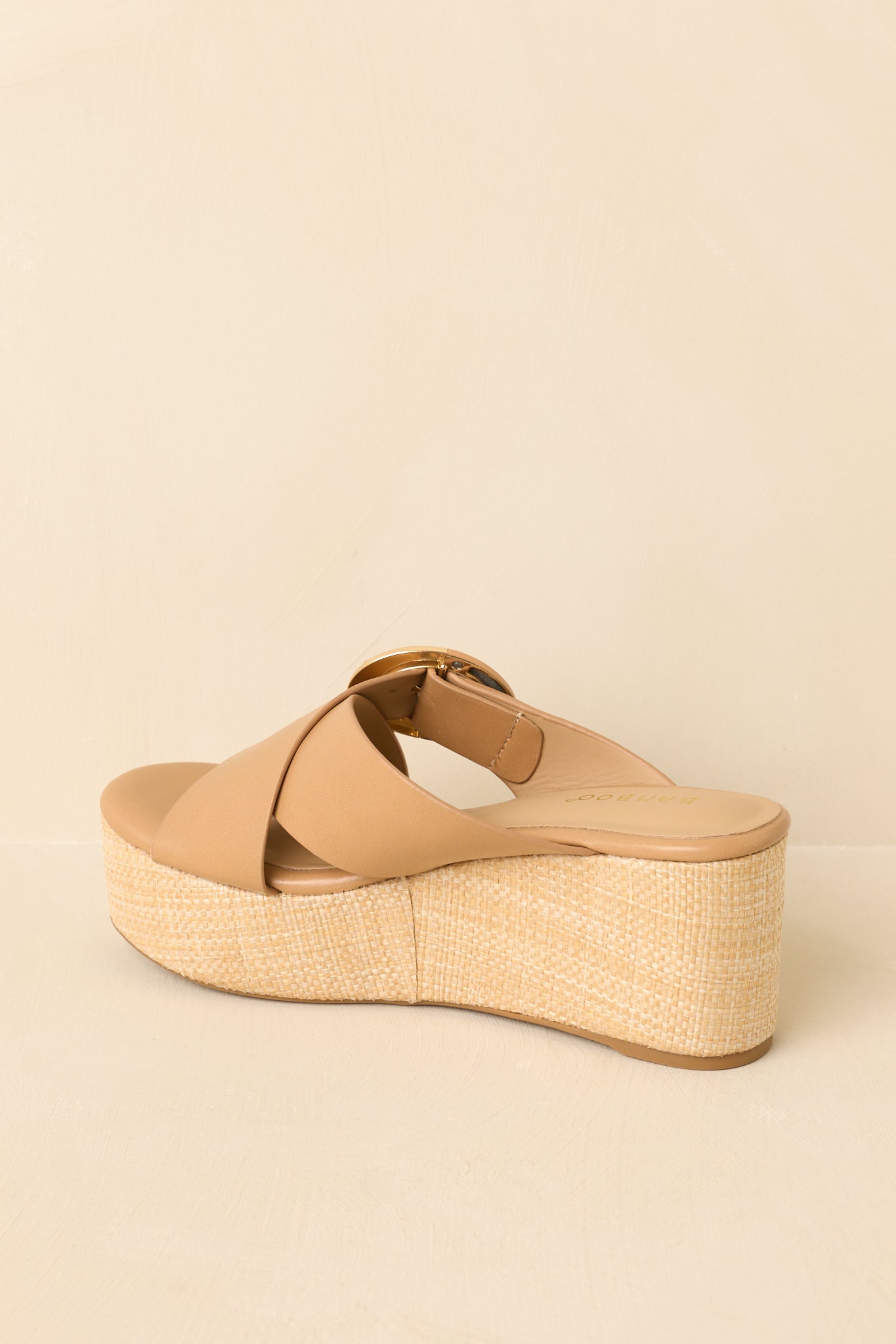 Back view of tan platform wedge sandals highlighting the textured wedge heel and clean, slip-on design.